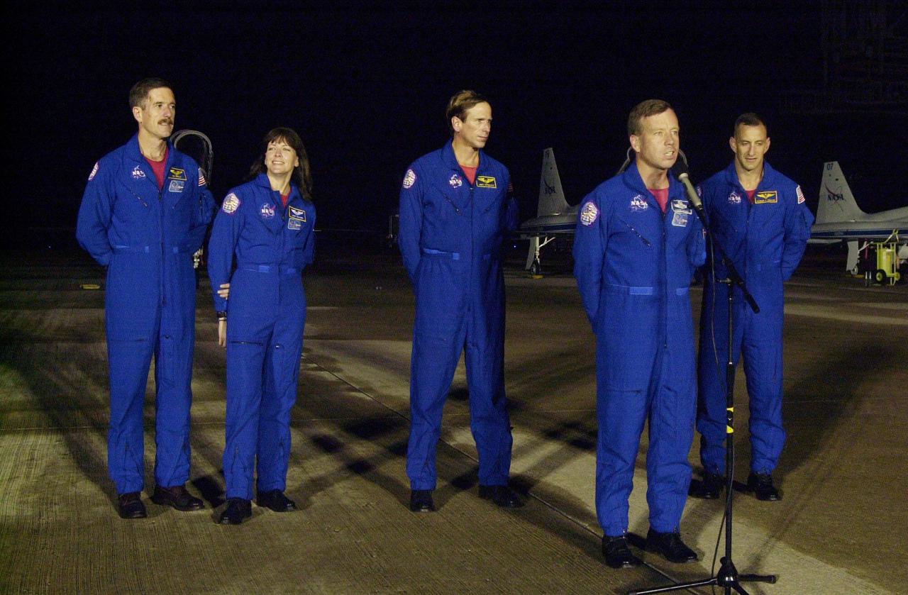 KENNEDY SPACE CENTER, Fla. -- The STS-104 crew talks to the media at the Shuttle Landing Facility after arriving at Kennedy Space Center to make final preparations for their launch. From left to right are Mission Specialists James F. Reilly, Janet Lynn Kavandi and Michael L. Gernhardt; Commander Steven W. Lindsey (at microphone); and Pilot Charles O. Hobaugh.  The launch of Atlantis on mission STS-104 is scheduled for July 12 from Launch Pad 39B. The mission is the 10th assembly flight to the International Space Station and carries the Joint Airlock Module, which will become the primary path for spacewalk entry and departure using both U.S. spacesuits and the Russian Orlan spacesuit for EVA activity