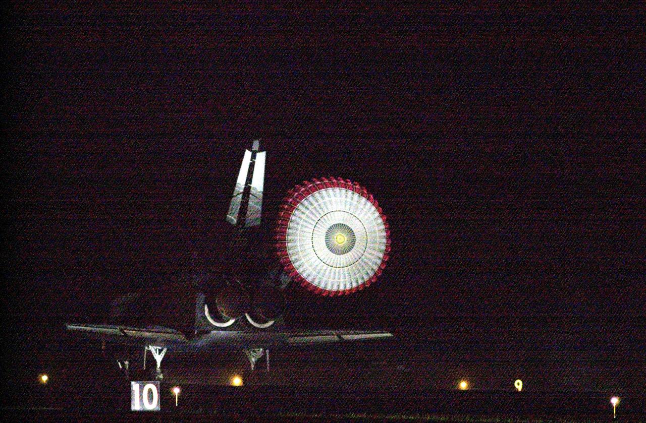 KENNEDY SPACE CENTER, Fla. -- With the drag chute slowing its speed, Atlantis prepares to land on Runway 15 at the Shuttle Landing Facility to complete a 12-day, 18-hour, 34-minute-long STS-104 mission. Main gear touchdown occurred at 11:38:55 p.m. EDT. At the controls is Commander Steven W. Lindsey. Other crew members on board are Pilot Charles Hobaugh and Mission Specialists Michael Gernhardt, Janet Lynn Kavandi and James F. Reilly. This is the 18th nighttime landing for a Space Shuttle, the 13th at Kennedy Space Center. The mission delivered the Joint Airlock Module to the International Space Station, completing the second phase of the assembly of the Space Station