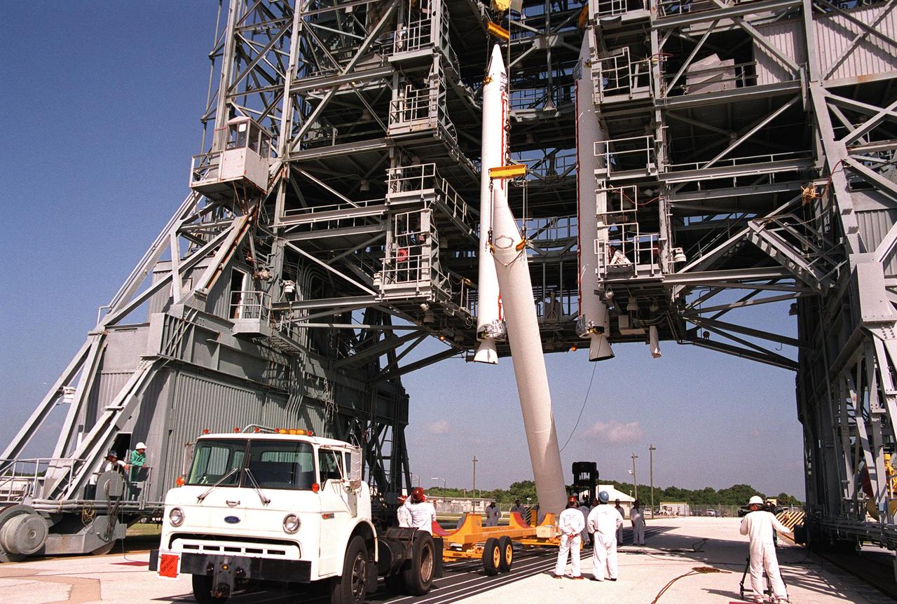 KENNEDY SPACE CENTER, Fla. -- A third solid rocket booster is raised to join the other two on Launch Complex 17-A, Cape Canaveral Air Force Station. They will be mated to the Delta II rocket for the Genesis spacecraft launch. Genesis will capture samples of the ions and elements in the solar wind and return them to Earth for scientists to use to determine the exact composition of the Sun and the solar system’s origin. NASA’s Genesis project is managed by the Jet Propulsion Laboratory in Pasadena, Calif. Lockheed Martin Astronautics built the Genesis spacecraft for NASA in Denver, Colo. Launch of Genesis aboard a Boeing Delta II rocket is scheduled for July 30 at 12:36 p.m. EDT