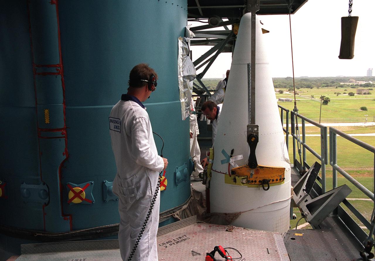 KENNEDY SPACE CENTER, Fla. -- Technicians on Launch Complex 17-A, Cape Canaveral Air Force Station, check the fittings on the solid rocket boosters surrounding the Delta II rocket that will launch the Genesis spacecraft. Genesis will capture samples of the ions and elements in the solar wind and return them to Earth for scientists to use to determine the exact composition of the Sun and the solar system’s origin. NASA’s Genesis project is managed by the Jet Propulsion Laboratory in Pasadena, Calif. Lockheed Martin Astronautics built the Genesis spacecraft for NASA in Denver, Colo. Launch of Genesis aboard a Boeing Delta II rocket is scheduled for July 30 at 12:36 p.m. EDT