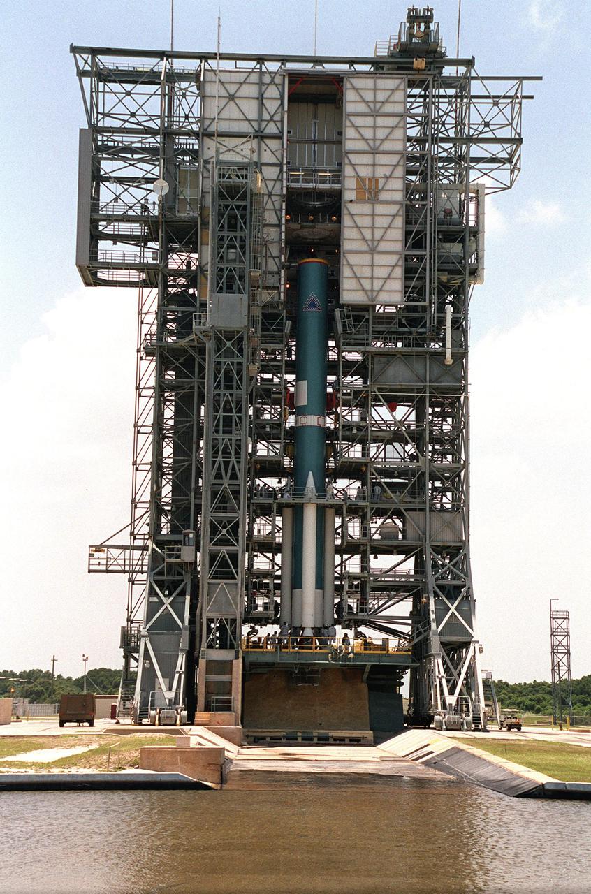 KENNEDY SPACE CENTER, Fla. -- -- Technicians work on the bottom of the solid rocket boosters and Delta II rocket that will launch the Genesis spacecraft. Genesis will capture samples of the ions and elements in the solar wind and return them to Earth for scientists to use to determine the exact composition of the Sun and the solar system’s origin. NASA’s Genesis project is managed by the Jet Propulsion Laboratory in Pasadena, Calif. Lockheed Martin Astronautics built the Genesis spacecraft for NASA in Denver, Colo. Launch of Genesis aboard a Boeing Delta II rocket is scheduled for July 30 at 12:36 p.m. EDT