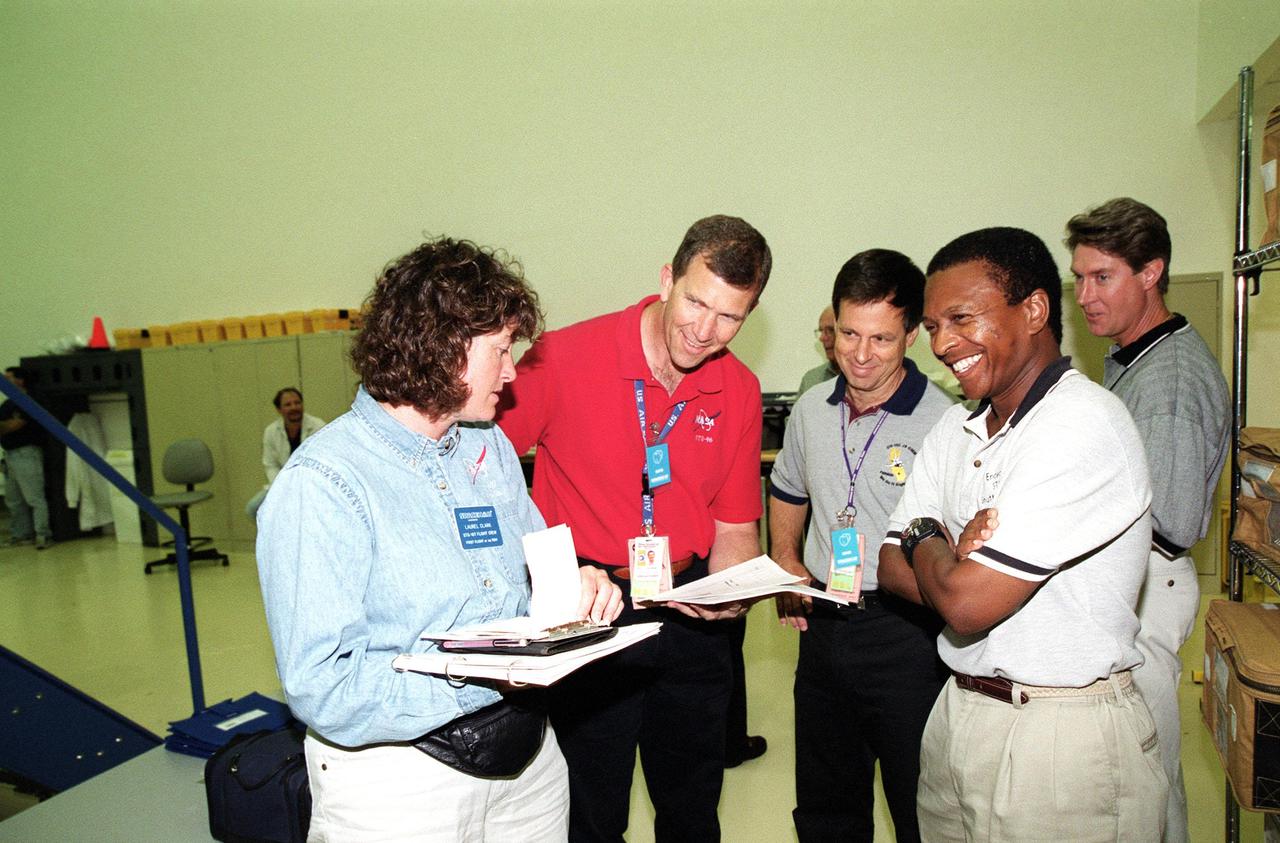 KENNEDY SPACE CENTER, Fla. -- At SPACEHAB, Cape Canaveral, Fla., the STS-107 crew takes part in Crew Equipment Interface Test (CEIT) activities. From left are Mission Specialist Laurel Blair Salton Clark, Commander Rick Douglas Husband, Payload Specialist Ilan Ramon, of Israel, and Payload Commander Michael P. Anderson. A trainer is at far right. As a research mission, STS-107 will carry the Spacehab Double Module in its first research flight into space and a broad collection of experiments ranging from material science to life science. The CEIT activities enable the crew to perform certain flight operations, operate experiments in a flight-like environment, evaluate stowage locations and obtain additional exposure to specific experiment operations. Other STS-107 crew members are Pilot William C. McCool and Mission Specialists Kalpana Chawla and David M. Brown. STS-107 is scheduled for launch May 23, 2002