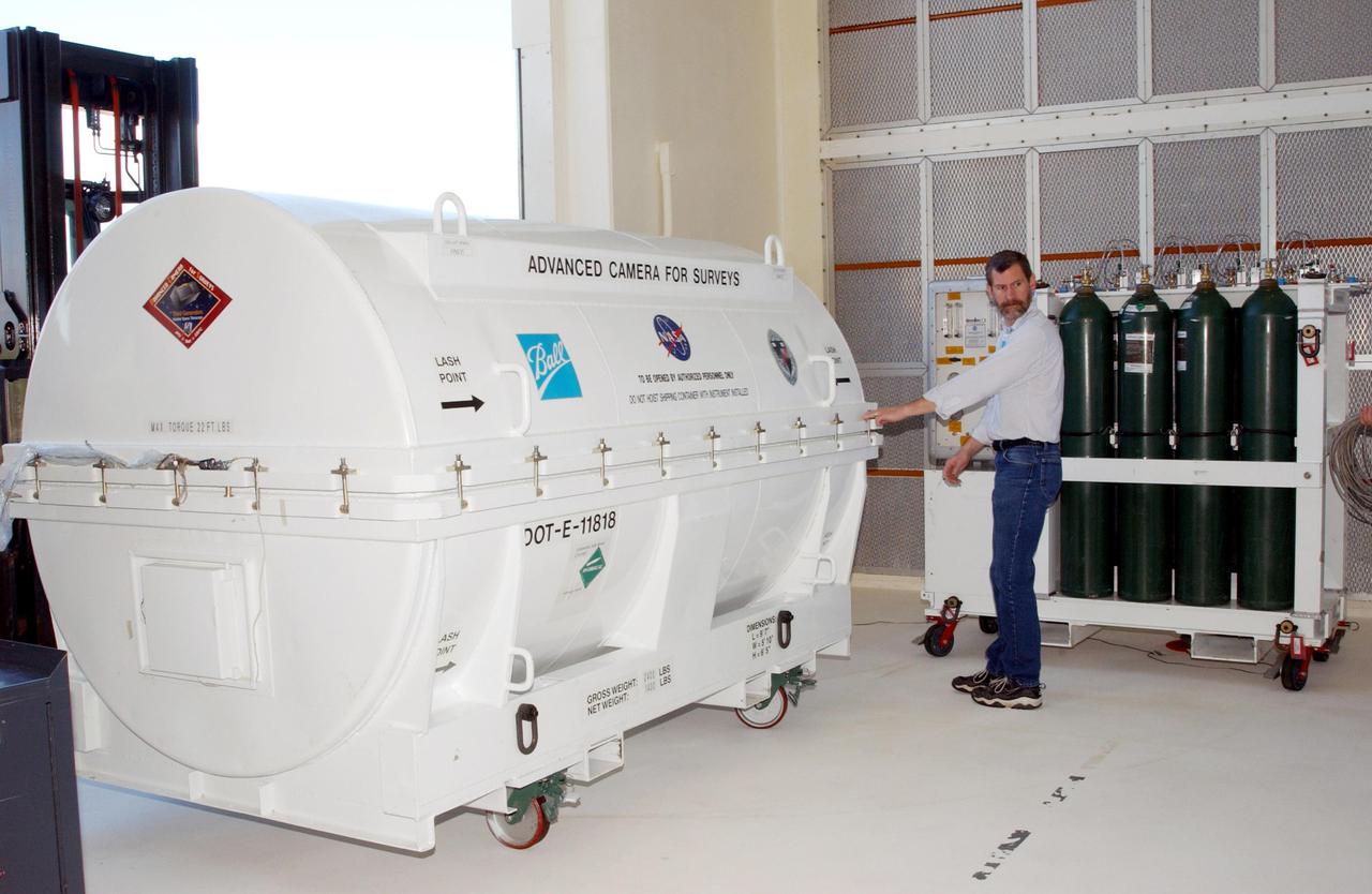 KENNEDY SPACE CENTER, Fla. -- A piece of equipment for Hubble Space Telescope Servicing mission is moved inside Hangar AE, Cape Canaveral.  In the canister is the Advanced Camera for Surveys (ACS). The ACS will increase the discovery efficiency of the HST by a factor of ten. It consists of three electronic cameras and a complement of filters and dispersers that detect light from the ultraviolet to the near infrared (1200 - 10,000 angstroms).  The ACS was built through a collaborative effort between Johns Hopkins University, Goddard Space Flight Center, Ball Aerospace Corporation and Space Telescope Science Institute. The goal of the mission, STS-109,  is to service the HST, replacing Solar Array 2 with Solar Array 3, replacing the Power Control Unit, removing the Faint Object Camera and installing the ACS, installing the Near Infrared Camera and Multi-Object Spectrometer (NICMOS) Cooling System, and installing New Outer Blanket Layer insulation on bays 5 through 8.  Mission STS-109 is scheduled for launch Feb. 14, 2002