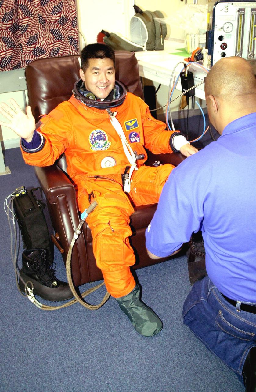 KENNEDY SPACE CENTER, Fla. -  STS-108 Mission Specialist Daniel M. Tani is happy to be suiting up for launch before heading to Launch Pad 39B and Space Shuttle Endeavour. Top priorities for the STS-108 (UF-1) mission of Endeavour are rotation of the International Space Station Expedition 3 and Expedition 4 crews; bringing water, equipment and supplies to the station in the Multi-Purpose Logistics Module Raffaello; and the crew's completion of robotics tasks and a spacewalk to install thermal blankets over two pieces of equipment at the bases of the Space Station's solar wings.   Launch is scheduled for 5:45 p.m. EST Dec. 4, 2001, from Launch Pad 39B