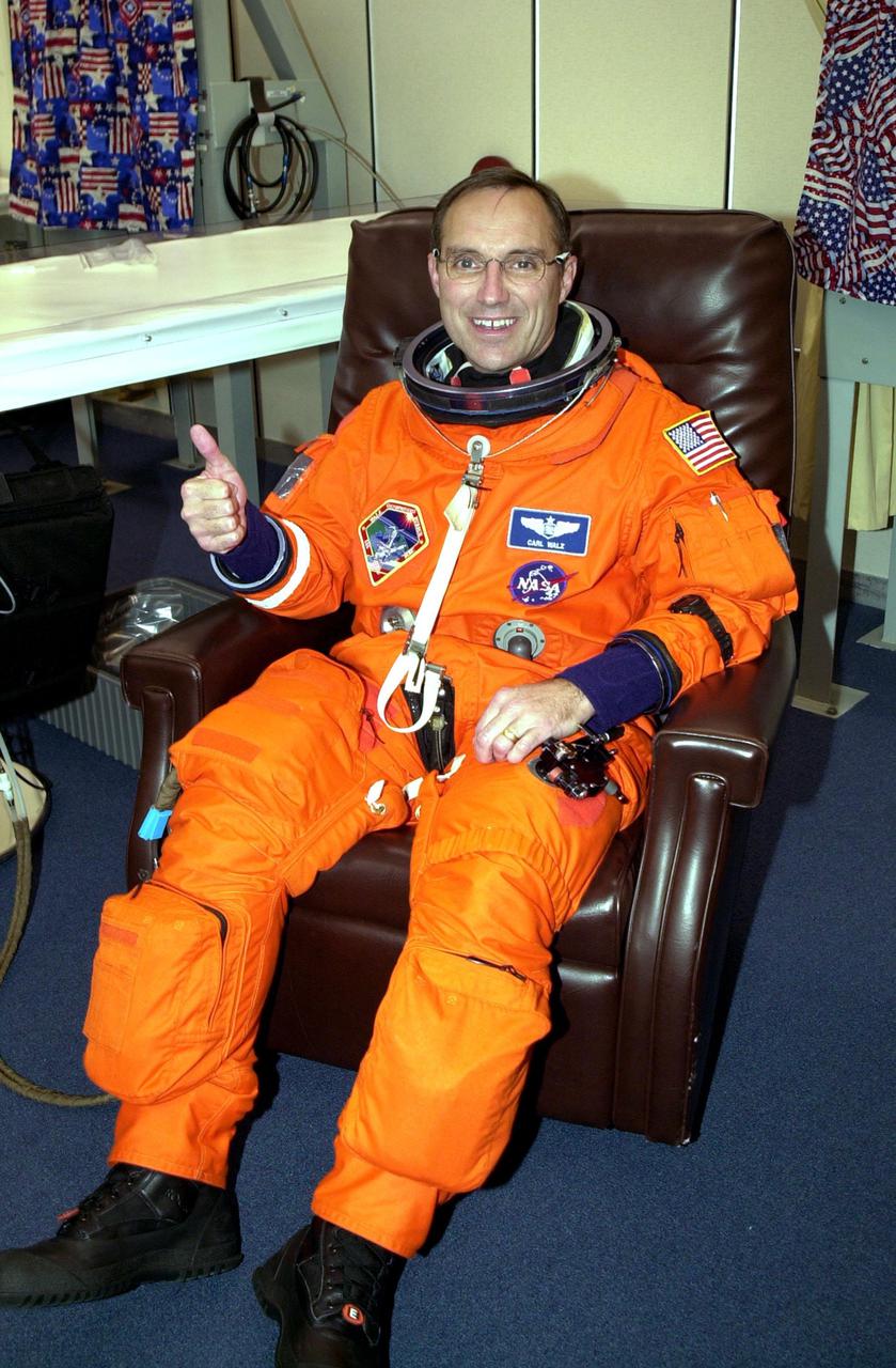 KENNEDY SPACE CENTER, Fla. -- During suitup, Expedition 4 crew member Carl E. Walz gives a thumbs up for launch. The Expedition 4 crew will be traveling to the International Space Station on mission STS-108 aboard Space Shuttle Endeavour. Top priorities for the 11-day STS-108 (UF-1) mission are the rotation of the Expedition 3 and 4 crews; bringing water, equipment and supplies to the station in the Multi-Purpose Logistics Module Raffaello; and the crew's completion of robotics tasks and a spacewalk to install thermal blankets over two pieces of equipment at the bases of the Space Station's solar wings. Launch is scheduled for 5:45 p.m. EST Dec. 4, 2001, from Launch Pad 39B
