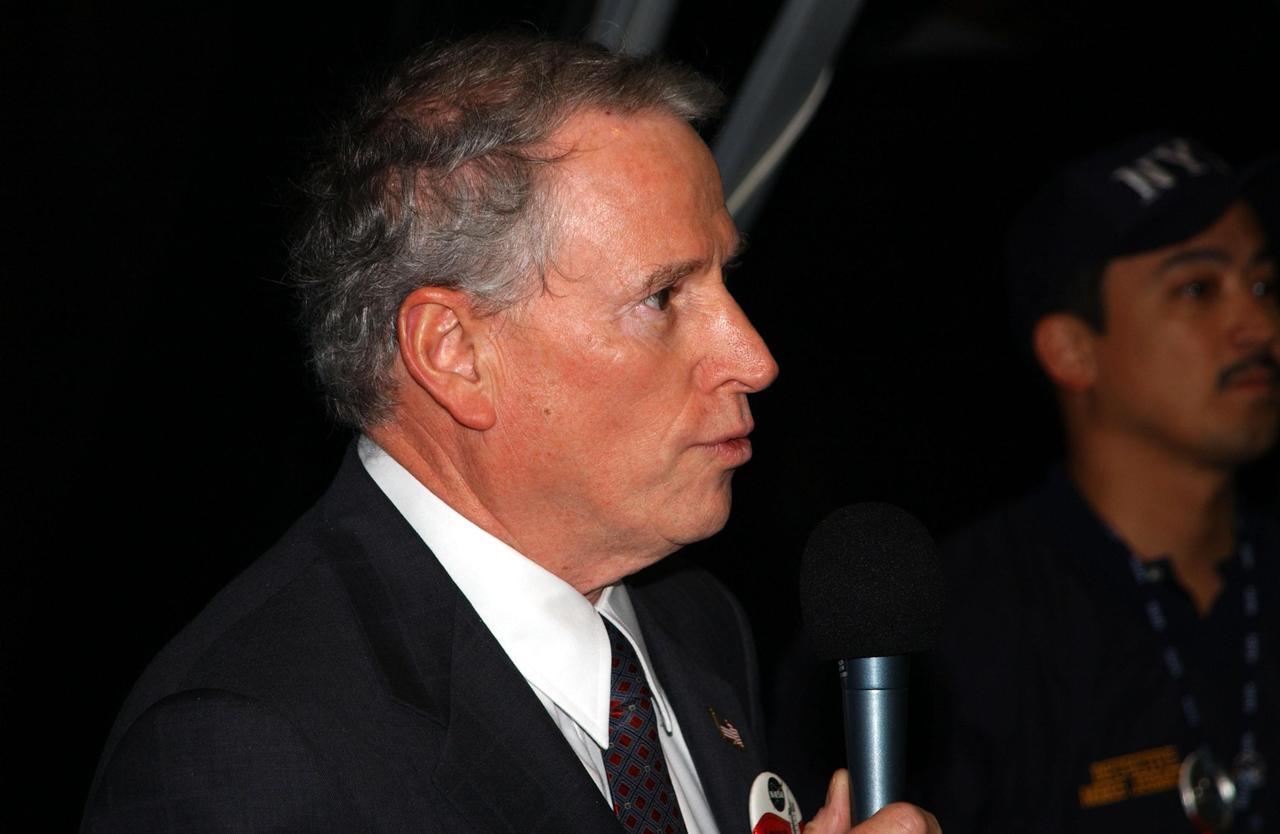KENNEDY SPACE CENTER, Fla. -- After watching the launch of Space Shuttle Endeavour on mission STS-108, NASA's Acting Administrator Daniel Mulville (left) speaks to workers and guests in the Firiing Room, Launch Control Center. With him, at right, is New York Police Department Detective Michael Jermyn, who attended the launch as a guest representing the New York Police and Fire Departments whose members lost their lives in the September 11 attacks. Endeavour is carrying 6,000 flags that will be given to the families of those who died in the fall of the Twin Towers. Liftoff of Endeavour occurred at 5:19:28 p.m. EST (22:19.28 GMT). Endeavour will dock with the International Space Station on Dec. 7. STS-108 is the final Shuttle mission of 2001and the 107th Shuttle flight overall. It is the 12th flight to the Space Station. Landing of the orbiter at KSC's Shuttle Landing Facility is targeted for 1:05 p.m. EST (18:05 p.m. GMT) Dec. 16