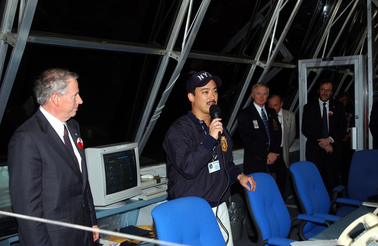 KENNEDY SPACE CENTER, Fla. -- After watching the launch of Space Shuttle Endeavour on mission STS-108 from the Firing Room of Launch Control Center, New York Police Department Detective Michael Jermyn praises the efforts of the workers on the successful launch. He is flanked by NASA's Acting Administrator Daniel Mulville (left) and Center Director Roy Bridges Jr. (right). Jermyn attended the launch as a guest representing the New York Police and Fire Departments whose members lost their lives in the September 11 attacks. Endeavour is carrying 6,000 flags that will be given to the families of those who died in the fall of the Twin Towers. Liftoff of Endeavour occurred at 5:19:28 p.m. EST (22:19.28 GMT). Endeavour will dock with the International Space Station on Dec. 7. STS-108 is the final Shuttle mission of 2001and the 107th Shuttle flight overall. It is the 12th flight to the Space Station. Landing of the orbiter at KSC's Shuttle Landing Facility is targeted for 1:05 p.m. EST (18:05 p.m. GMT) Dec. 16