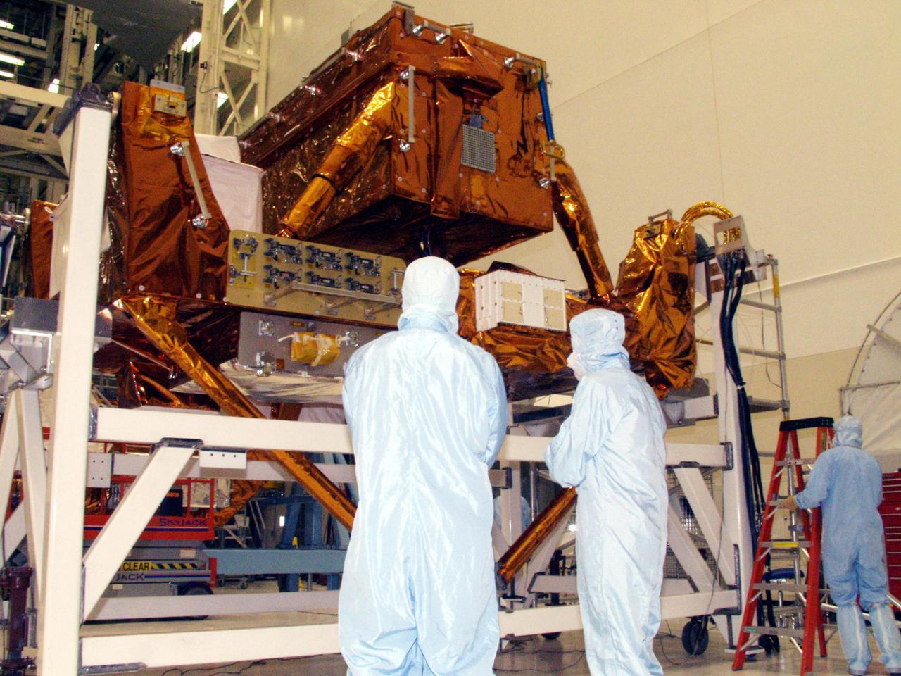 KENNEDY SPACE CENTER, FLA. -- Workers in the Vertical Processing Facility take a close look at the Axial Science Instrument Protective Enclosure (ASIPE), which will house the Advanced Camera for Surveys (ACS), part of the STS-109 flight hardware for maintenance of the Hubble Space Telescope (HST). The hardware is installed on four principle payload carriers. The STS-109 launch aboard Columbia is targeted for Feb. 14, 2002, and will be the 108th flight in the Space Shuttle program