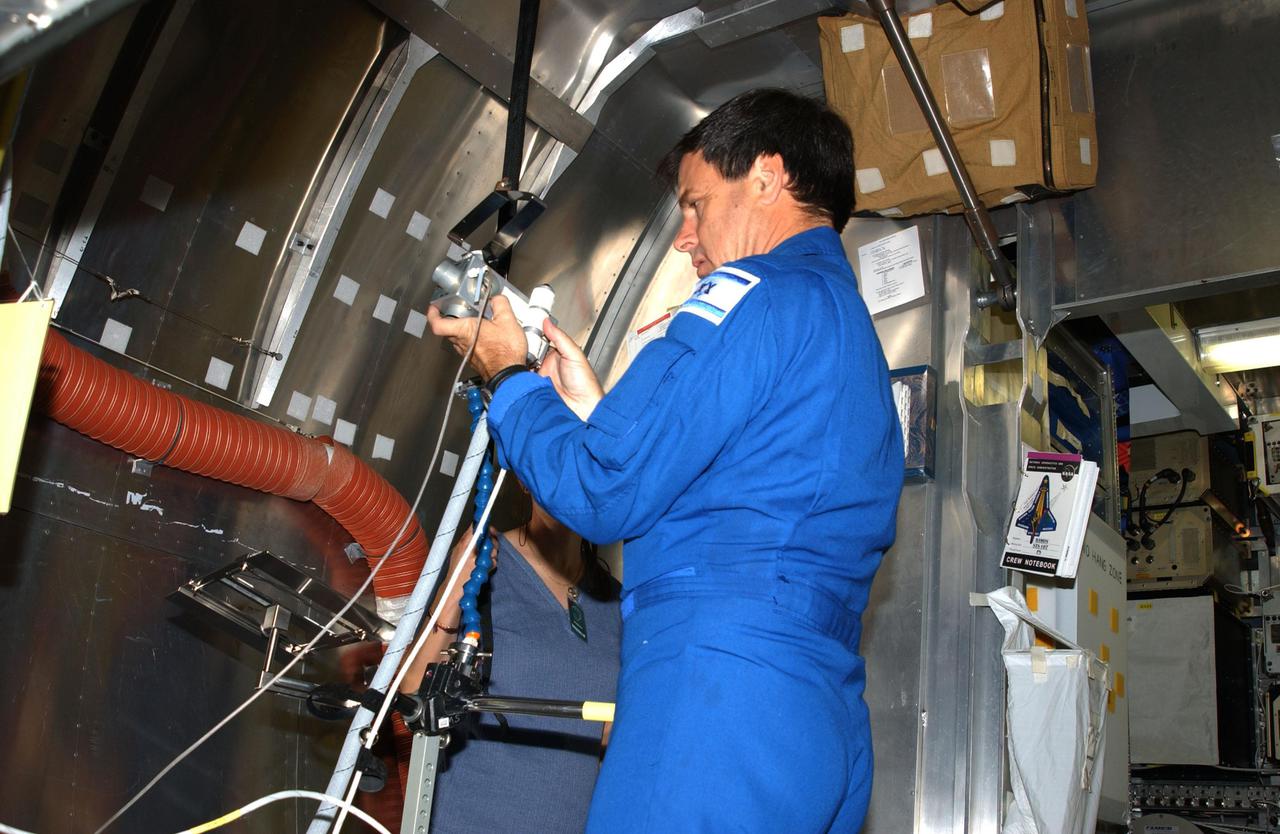 KENNEDY SPACE CENTER, FLA. --  STS-107 Payload Specialist Ilan Ramon checks equipment during crew training at SPACEHAB, Cape Canaveral, Fla.   STS-107 is a research mission, and the primary payload is the first flight of the SHI Research Double Module (SHI_RDM). The experiments range from material sciences to life sciences (many rats).  Among the experiments is a Hitchhiker carrier system, modular and expandable in accordance with payload requirements.  STS-107 is scheduled to launch in June 2002.