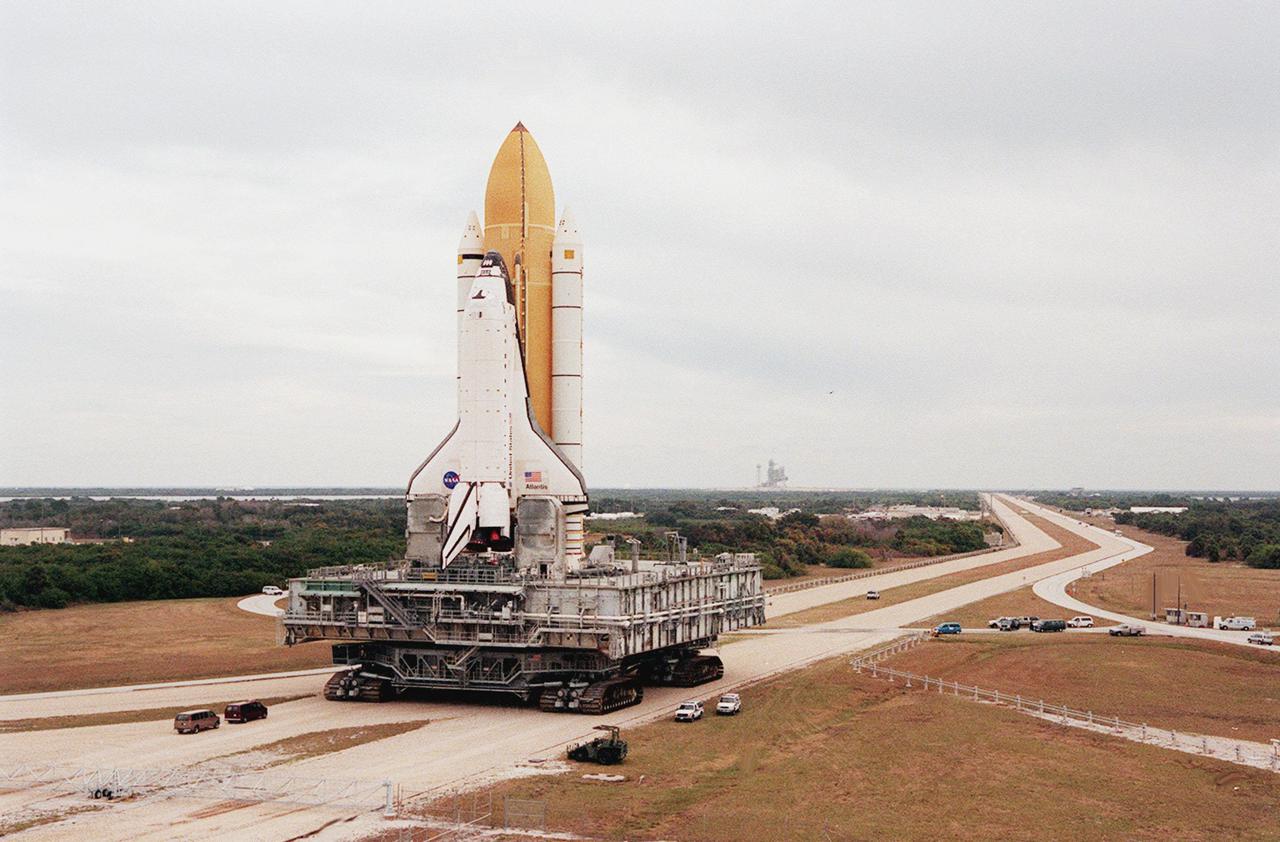 KENNEDY SPACE CENTER, Fla. -- Under gray cloudy skies, Space Shuttle Atlantis inches its way to Launch Pad 39A , barely visible in the background. The journey is a distance of just over 3 miles. Atlantis will fly on mission STS-98, the seventh construction flight to the International Space Station. The orbiter will carry in its payload bay the U.S. Laboratory, named Destiny, that will have five system racks already installed inside the module. After delivery of electronics in the lab, electrically powered attitude control for Control Moment Gyroscopes will be activated. Atlantis is scheduled for launch no earlier than Jan. 19, 2001, with a crew of five