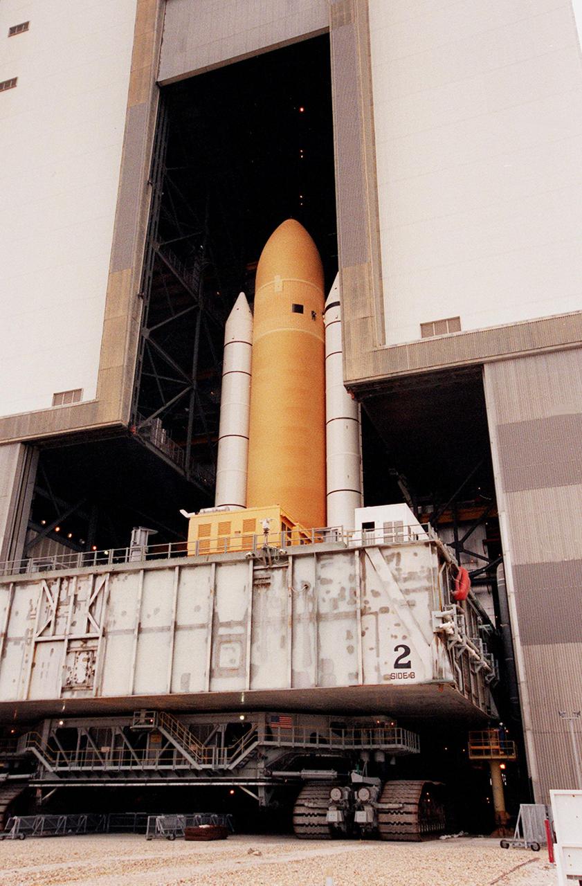 KENNEDY SPACE CENTER, FLA. -- Seen from outside, Space Shuttle Atlantis moves back inside the Vehicle Assembly Building after an aborted rollout to Launch Pad 39A. Atlantis will fly on mission STS-98, the seventh construction flight to the International Space Station. The orbiter will carry in its payload bay the U.S. Laboratory, named Destiny, that will have five system racks already installed inside the module. After delivery of electronics in the lab, electrically powered attitude control for Control Moment Gyroscopes will be activated. Atlantis is scheduled for launch no earlier than Jan. 19, 2001, with a crew of five