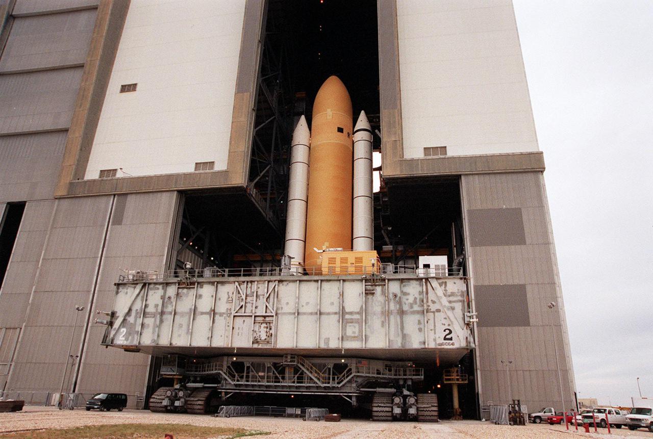 KENNEDY SPACE CENTER, FLA. -- Space Shuttle Atlantis moves back inside the Vehicle Assembly Building after an aborted rollout to Launch Pad 39A. Atlantis will fly on mission STS-98, the seventh construction flight to the International Space Station. The orbiter will carry in its payload bay the U.S. Laboratory, named Destiny, that will have five system racks already installed inside the module. After delivery of electronics in the lab, electrically powered attitude control for Control Moment Gyroscopes will be activated. Atlantis is scheduled for launch no earlier than Jan. 19, 2001, with a crew of five