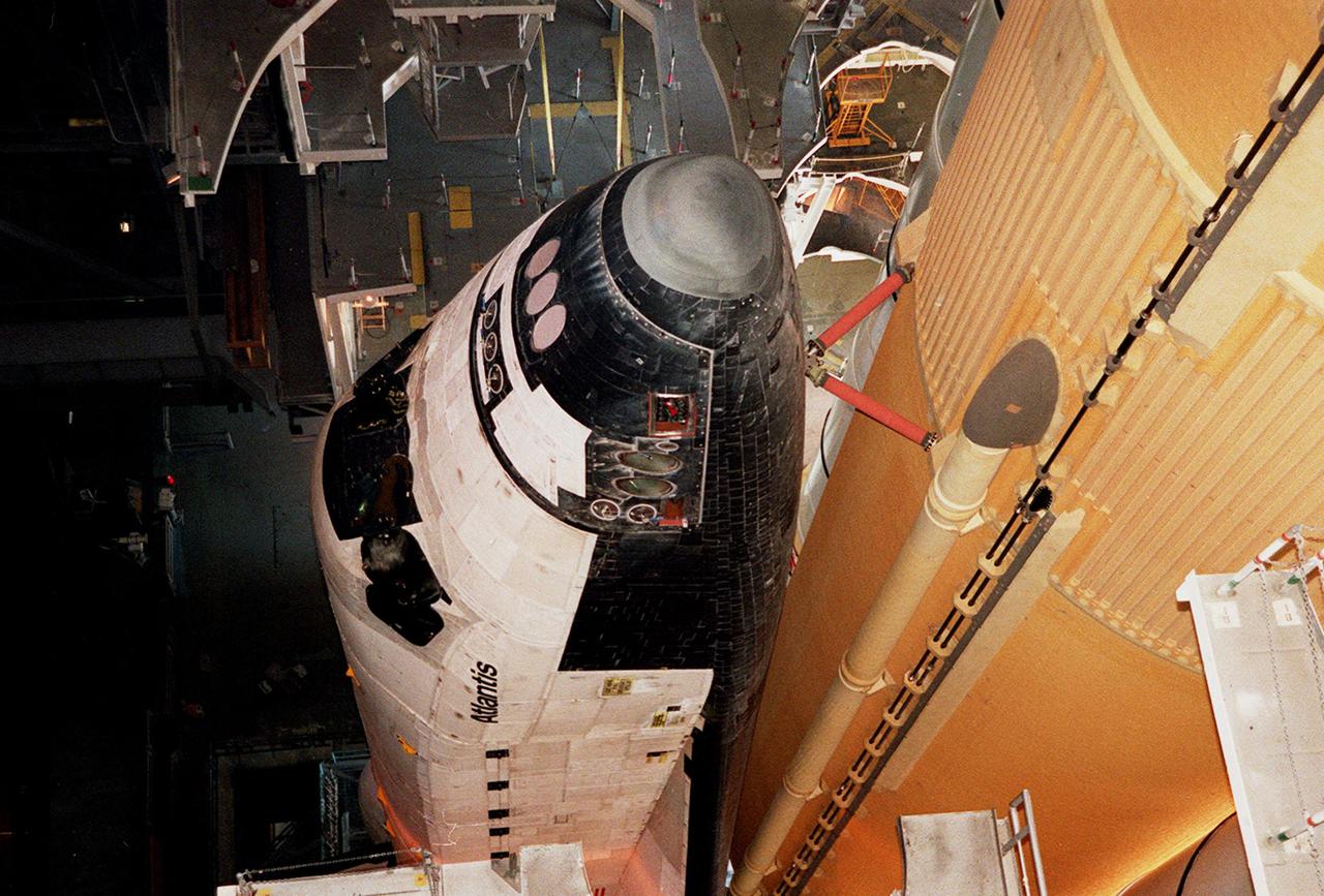 KENNEDY SPACE CENTER, Fla. -- The nose of Atlantis is seen in this closeup, along with the braces that attach it to the external tank at right. Space Shuttle Atlantis is making its second rollout attempt to Launch Pad 39A. An attempt to roll out on Jan. 2 incurred a failed computer processor on the crawler transporter and the Shuttle was returned to the Vehicle Assembly Building using a secondary computer processor on the vehicle. Atlantis will fly on mission STS-98, the seventh construction flight to the International Space Station, carrying the U.S. Laboratory, named Destiny. The lab will have five system racks already installed inside the module. After delivery of electronics in the lab, electrically powered attitude control for Control Moment Gyroscopes will be activated. Atlantis is scheduled for launch no earlier than Jan. 19, 2001, with a crew of five
