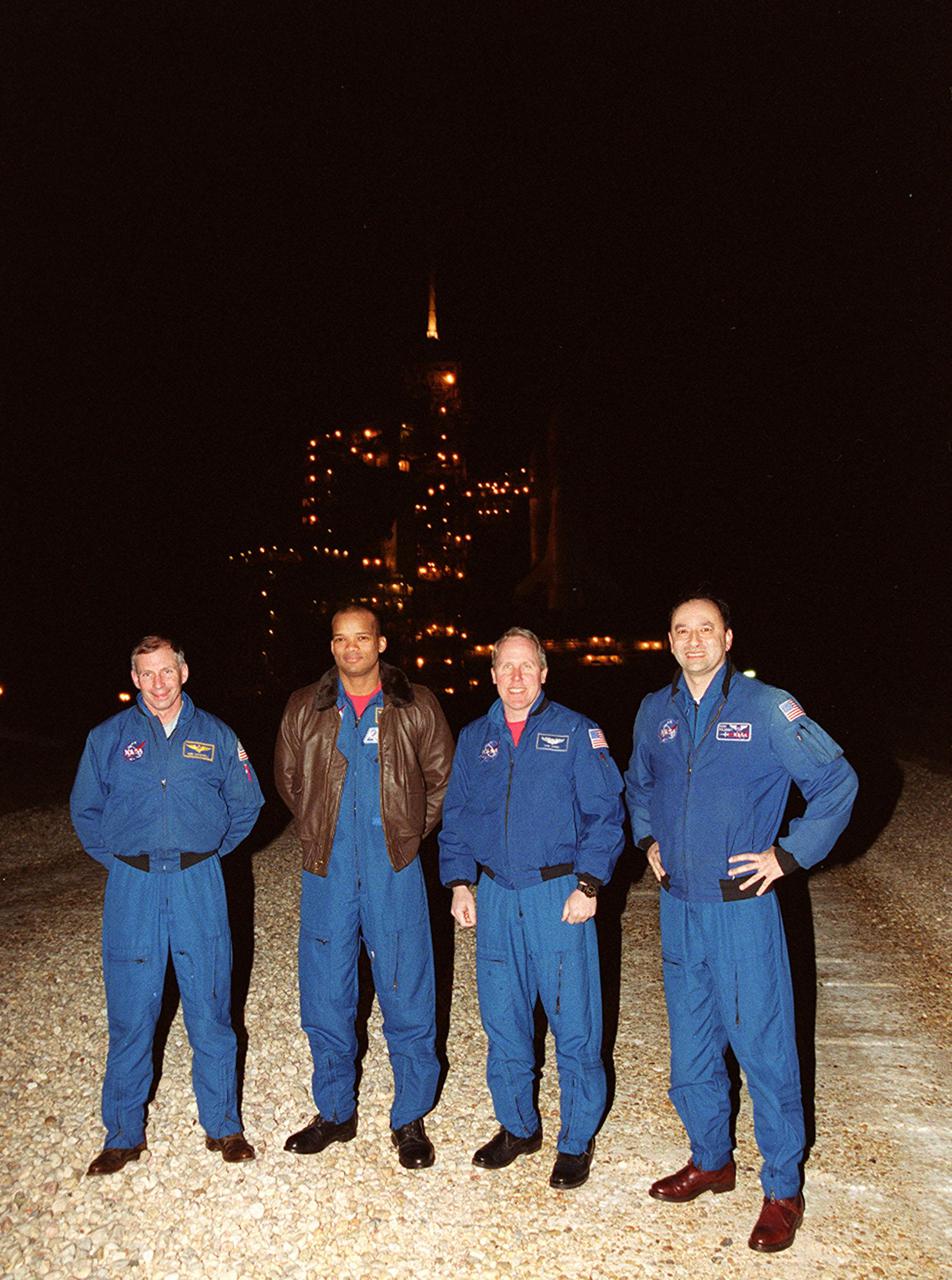 Members of the STS-98 crew pause for a photo after their arrival at KSC. From left, they are Commander Ken Cockrell, Mission Specialists Robert Curbeam and Thomas Jones, and Pilot Mark Polansky. Missing is Mission Specialist Marsha Ivins who was planning to arrive later. The crew is at KSC to take part in Terminal Countdown Test Demonstration activities in preparation for launch. They will be training in emergency procedures from the pad, checking the payload and taking part in a simulated countdown. The payload for the mission is the U.S. Lab Destiny, a key element in the construction of the International Space Station. The lab has five system racks already installed inside the module. After delivery of electronics in the lab, electrically powered attitude control for Control Moment Gyroscopes will be activated. STS-98 is the seventh construction flight to the ISS