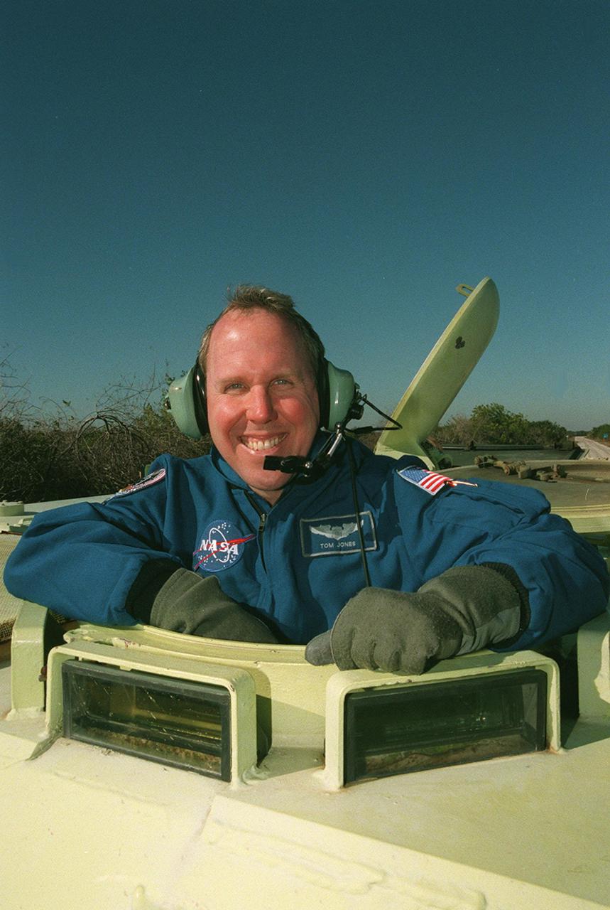 A smiling Thomas Jones, one of the mission specialists on STS-98, gets ready to take the driver’s seat in an M-113 armored carrier, part of emergency egress training at Launch Pad 39A. In the event of an emergency at the pad prior to launch, the carrier could be used to transport the crew to a nearby bunker or farther. The STS-98 crew is at KSC to take part in Terminal Countdown Demonstration Test activities, which also includes a simulated launch countdown. STS-98 is the seventh construction flight to the International Space Station, carrying as payload the U.S. Lab Destiny, a key element in the construction of the ISS