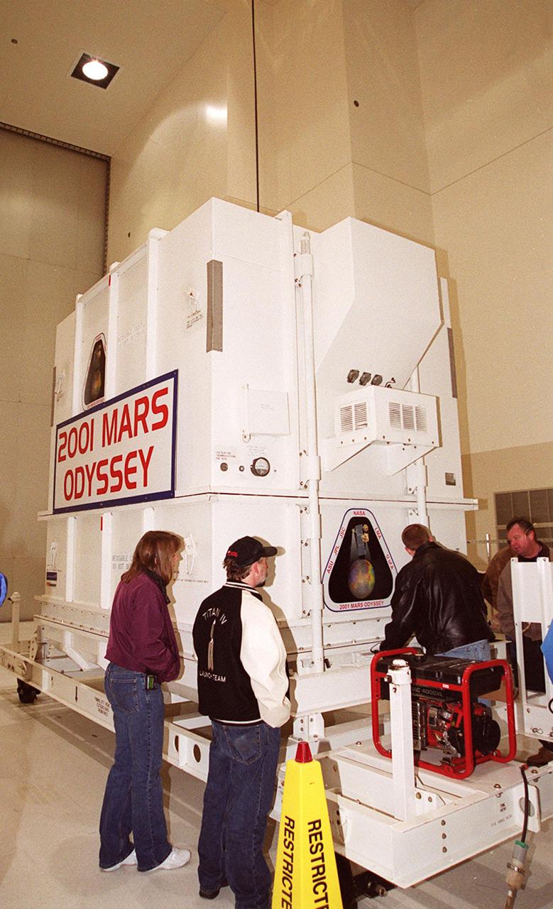 The crated 2001 Mars Odyssey spacecraft rests safely inside the Spacecraft Assembly and Encapsulation Facility 2 (SAEF-2) located in the KSC Industrial Area. The spacecraft arrived at KSC’s Shuttle Landing Facility aboard an Air Force C-17 cargo airplane that brought it from Denver, Colo.., location of the Lockheed Martin plant where the spacecraft was built. In the SAEF, Odyssey will undergo final assembly and checkout. This includes installation of two of the three science instruments, integration of the three-panel solar array, and a spacecraft functional test. It will be fueled and then mated to an upper stage booster, the final activities before going to the launch pad. Launch is planned for April 7, 2001 the first day of a 21-day planetary window. Mars Odyssey will be inserted into an interplanetary trajectory by a Boeing Delta II launch vehicle from Pad A at Complex 17 at the Cape Canaveral Air Force Station, Fla. The spacecraft will arrive at Mars on Oct. 20, 2001, for insertion into an initial elliptical capture orbit. Its final operational altitude will be a 250-mile-high, Sun-synchronous polar orbit. Mars Odyssey will spend two years mapping the planet's surface and measuring its environment