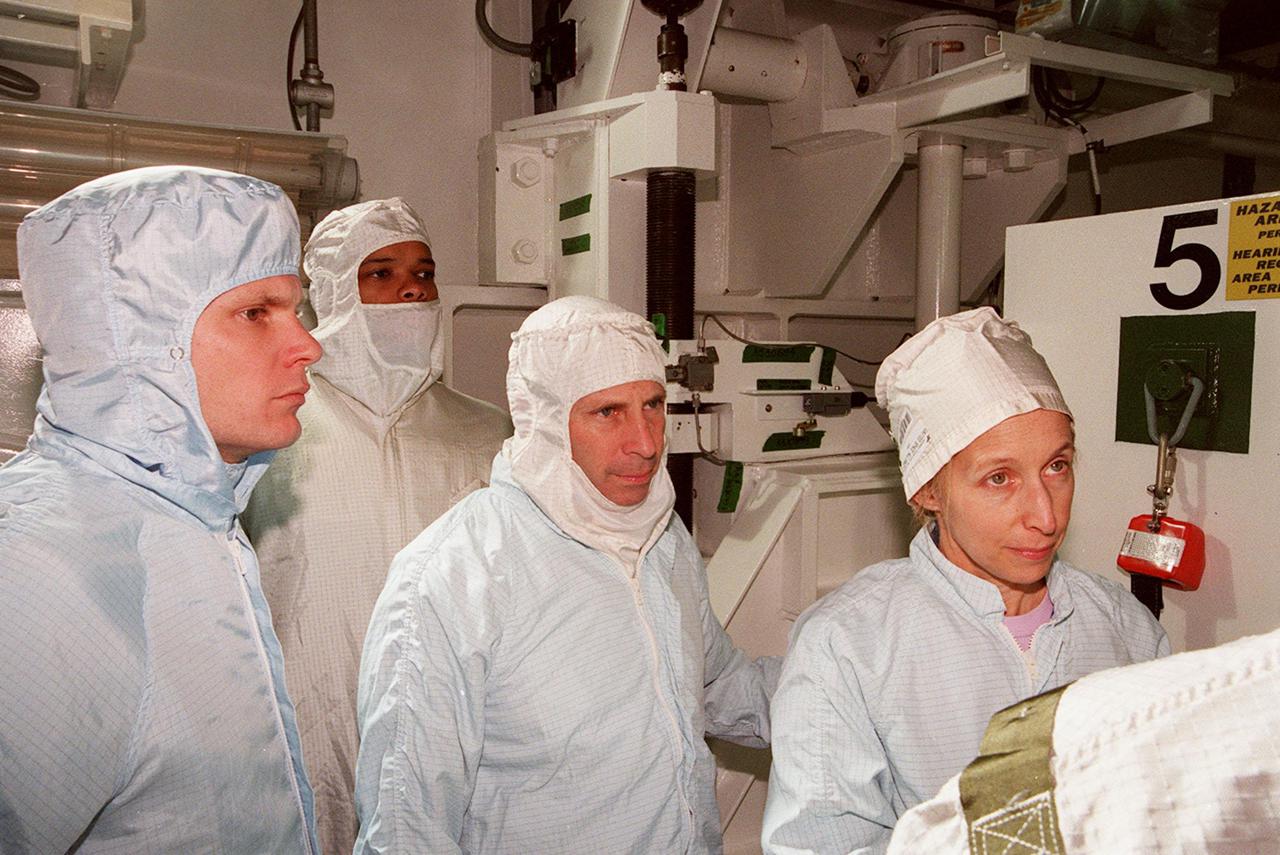 KENNEDY SPACE CENTER, FLA. -- Along with Scott Thurston (left), of the VITT office, members of the STS-98 crew Mission Specialist Robert Curbeam, Commander Ken Cockrell and Mission Specialist Marsha Ivins are in Atlantis’ payload bay to check out their mission payload, the U.S. Lab Destiny. The crew is at KSC for Terminal Countdown Demonstration Test activities, which also include a simulated launch countdown. A key element in the construction of the International Space Station, Destiny is a pressurized module designed to accommodate pressurized payloads. It has a capacity of 24 rack locations. Payload racks will occupy 13 locations especially designed to support experiments. The module already has five system racks installed inside. Launch of STS-98 on its 11-day mission is scheduled for Jan. 19 at 2:11 a.m. EST