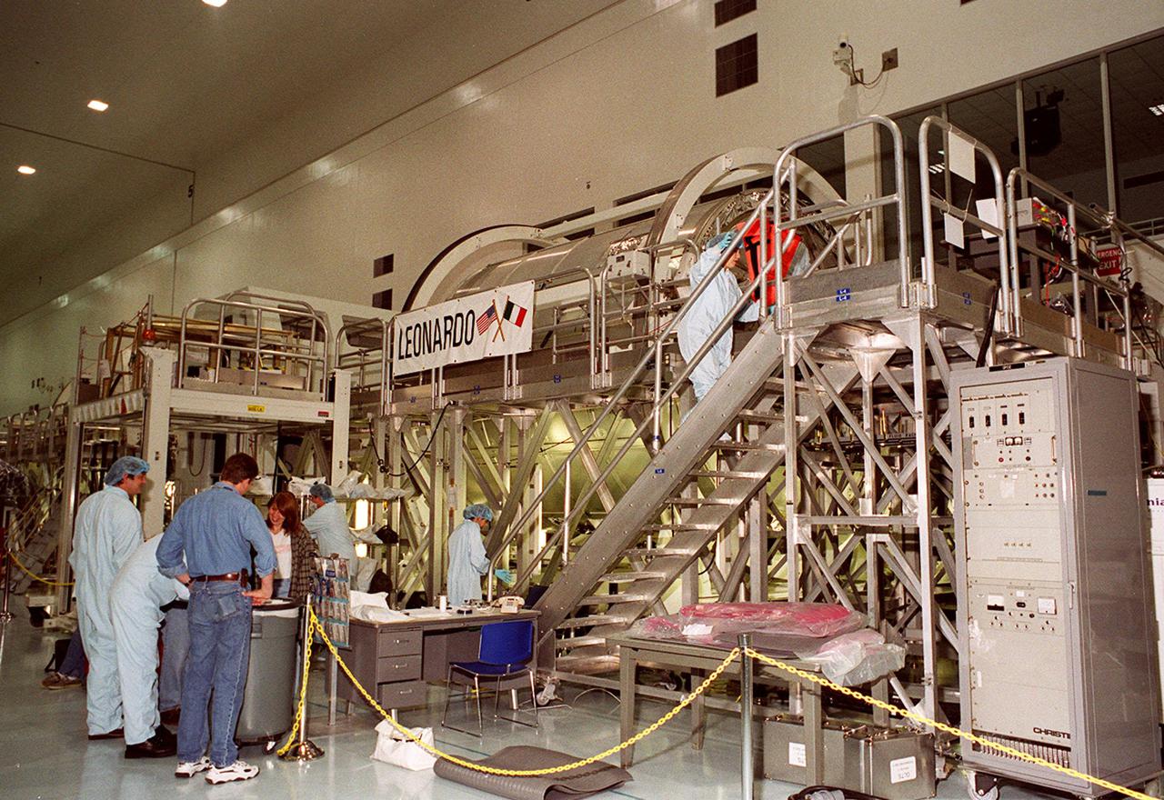 KENNEDY SPACE CENTER, FLA. -- In the Space Station Processing Facility, Multi-Purpose Logistics Module Leonardo has the attention of workers and some of the STS-102 crew. The MPLM, part of the payload on the STS-102 mission, is the first of three pressurized modules that will serve as the International Space Station’s “moving vans,” carrying laboratory racks filled with equipment, experiments and supplies to and from the Space Station aboard the Space Shuttle. Leonardo is scheduled to be launched in early March. On that flight, Leonardo will be filled with equipment and supplies to outfit the U.S. laboratory module Destiny. The mission will also be carrying the Expedition Two crew to the Space Station, replacing the Expedition One crew who will return on Shuttle Discovery