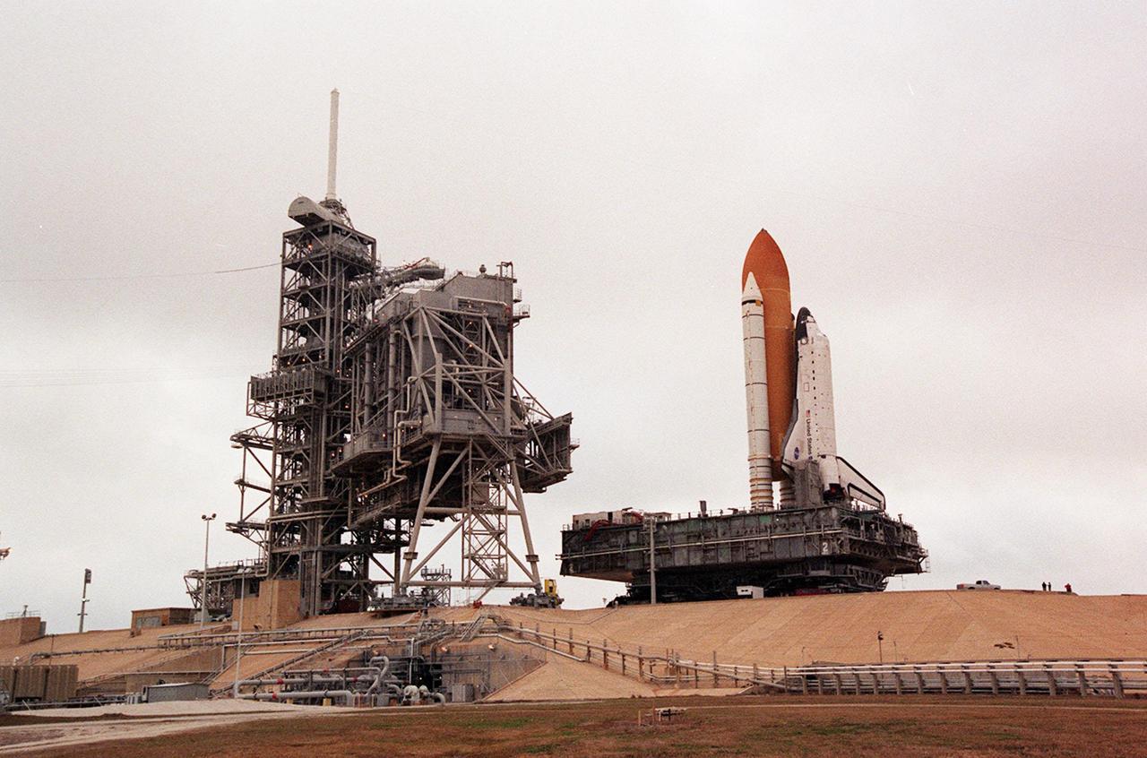 KENNEDY SPACE CENTER, FLA. -- Space Shuttle Atlantis begins rolling back to the Vehicle Assembly Building on the crawler-transporter. In the VAB workers will conduct inspections, make continuity checks and conduct X-ray analysis on the 36 solid rocket booster cables located inside each booster’s system tunnel. An extensive evaluation of NASA’s SRB cable inventory revealed conductor damage in four (of about 200) cables on the shelf. Shuttle managers decided to prove the integrity of the system tunnel cables already on Atlantis before launching Jan. 19. The launch has been rescheduled no earlier than Feb. 6