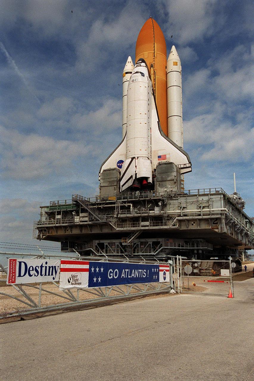KENNEDY SPACE CENTER, Fla. -- The gate outside Launch Pad 39A heralds the STS-98 launch as Space Shuttle Atlantis makes its way to the pad. The Shuttle had returned to the Vehicle Assembly Building from the launch pad in order to undergo tests on the solid rocket booster cables. A prior extensive evaluation of NASA’s SRB cable inventory on the shelf revealed conductor damage in four (of about 200) cables. Shuttle managers decided to prove the integrity of the system tunnel cables already on Atlantis, causing return of the Shuttle to the VAB a week ago. The Shuttle will undergo preparations for a rescheduled launch Feb. 7 at 6:11 p.m. EST