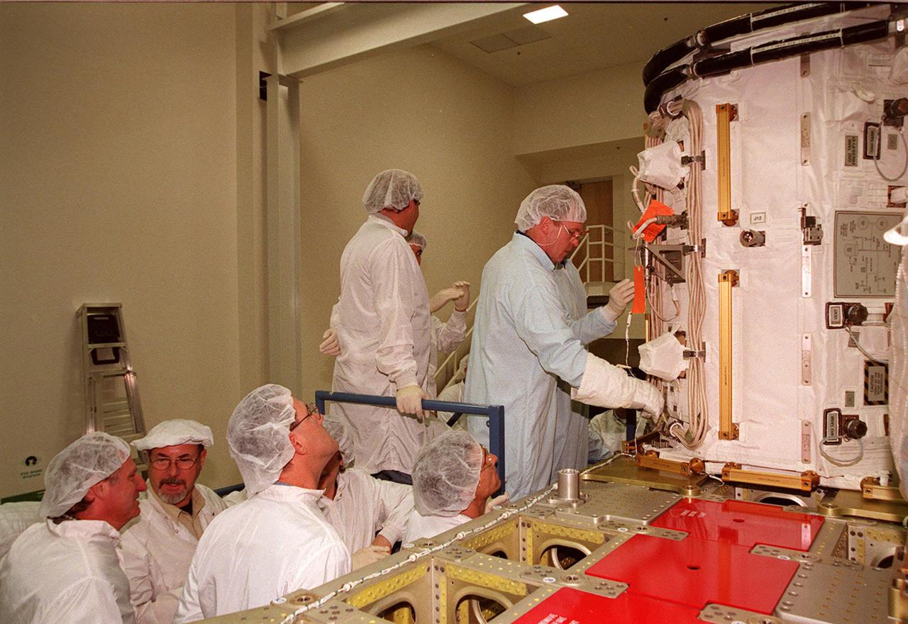 KENNEDY SPACE CENTER, FLA. -- At SPACEHAB, STS-102 Mission Specialist Andrew S.W. Thomas checks out the Early Ammonia Servicer under the watchful eyes of workers in the facility. Thomas and other crew members are at SPACEHAB to get acquainted with tools and equipment they will be using on their mission to the International Space Station. The second spacewalk of the mission will require the crew to transfer the Early Ammonia Servicer to the P6 truss. STS-102 is the 8th construction flight to the Space Station and will carry the Multi-Purpose Logistics Module Leonardo. On that flight, Leonardo will be filled with equipment and supplies to outfit the U.S. laboratory module Destiny. The mission will also be carrying the Expedition Two crew to the Space Station, replacing the Expedition One crew who will return on Shuttle Discovery. STS-102 is scheduled for launch March 8, 2001
