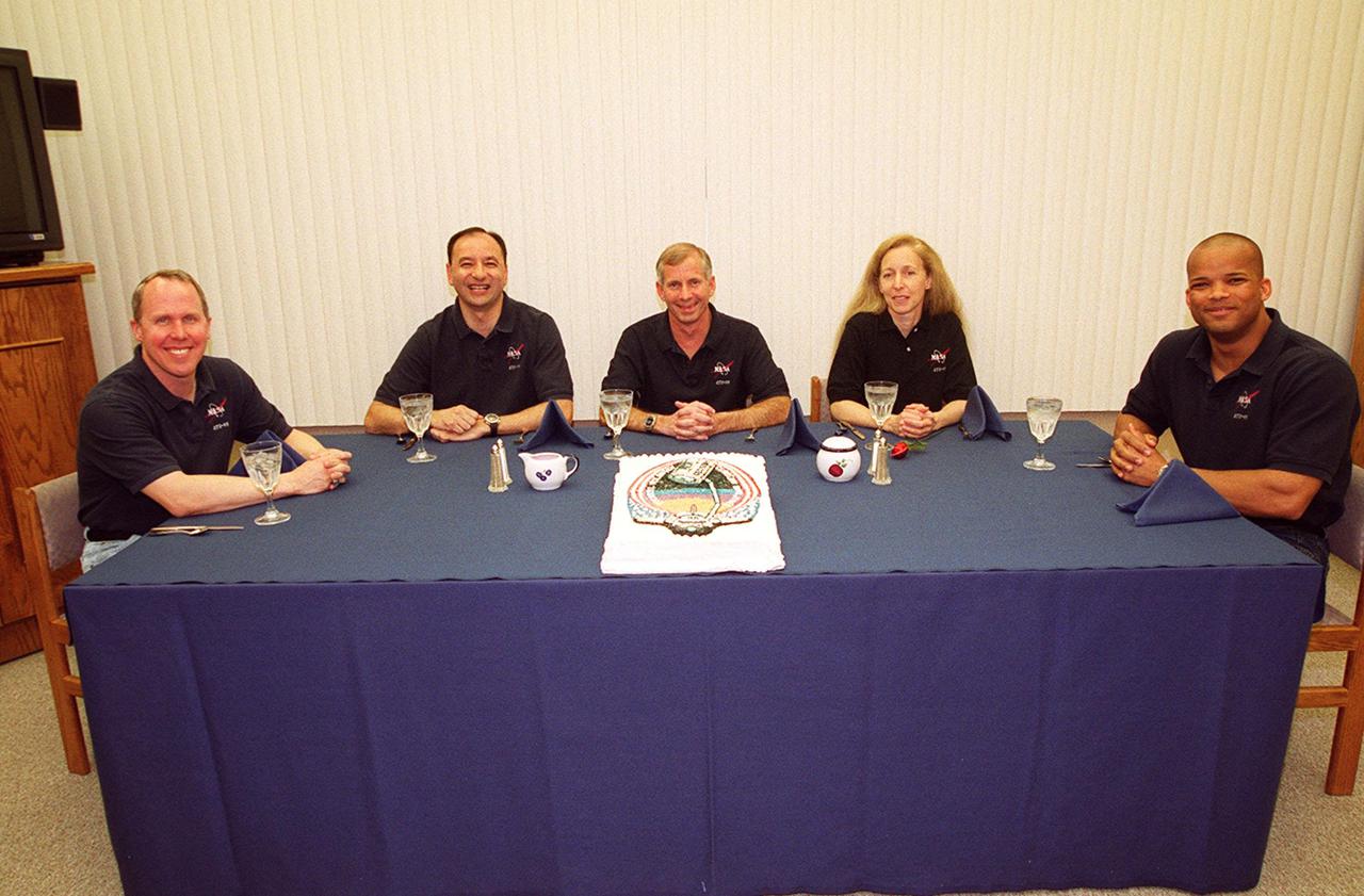 The STS-98 crew gathers around a table for a snack before getting ready for launch on Space Shuttle Atlantis. Seated left to right are Mission Specialist Thomas Jones, Pilot Mark Polansky, Commander Ken Cockrell and Mission Specialists Marsha Ivins and Robert Curbeam. STS-98 is the seventh construction flight to the International Space Station. Atlantis is carrying the U.S. Laboratory Destiny, a key module in the growth of the Space Station. Destiny will be attached to the Unity node on the Space Station using the Shuttle’s robotic arm. Three spacewalks, by Curbeam and Jones, are required to complete the planned construction work during the 11-day mission. Launch is targeted for 6:11 p.m. EST and the planned landing at KSC Feb. 18 about 1:39 p.m. This mission marks the seventh Shuttle flight to the Space Station, the 23rd flight of Atlantis and the 102nd flight overall in NASA’s Space Shuttle program