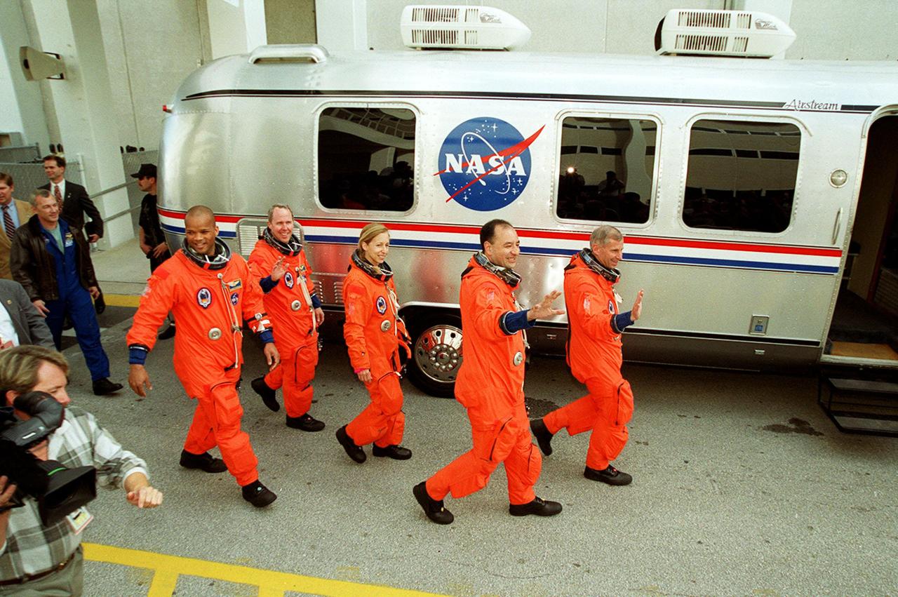 The STS-98 crew leaves the Operations and Checkout Building and heads for the “Astrovan” that will take them to Space Shuttle Atlantis on Launch Pad 39A. From left are Mission Specialists Robert Curbeam, Thomas Jones and Marsha Ivins, Pilot Mark Polansky and Commander Ken Cockrell. They will be flying the seventh construction flight to the International Space Station. Atlantis is carrying the U.S. Laboratory Destiny, a key module in the growth of the Space Station. Destiny will be attached to the Unity node on the Space Station using the Shuttle’s robotic arm. Three spacewalks are required to complete the planned construction work during the 11-day mission. Launch is targeted for 6:11 p.m. EST and the planned landing at KSC Feb. 18 about 1:39 p.m. This mission marks the seventh Shuttle flight to the Space Station, the 23rd flight of Atlantis and the 102nd flight overall in NASA’s Space Shuttle program