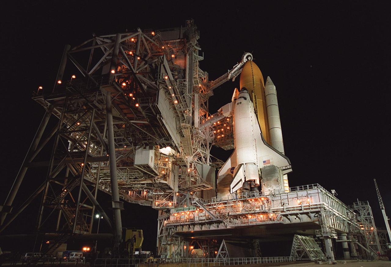 Space Shuttle Atlantis is revealed after rollback of the Rotating Service Structure. Extended to the side of Atlantis is the orbiter access arm, with the White Room at its end. The White Room is an environmentally controlled area that provides entry for the crew into Atlantis’s cockpit. Above the yellow-orange external tank is the Gaseous Oxygen Vent Arm, with the “beanie cap” vent hood raised. Before cryogenic loading, the hood will be lowered into position over the external tank vent louvers to vent gaseous oxygen vapors away from the Shuttle. Atlantis is carrying the U.S. Laboratory Destiny, a key module in the growth of the International Space Station. Destiny will be attached to the Unity node on the Space Station using the Shuttle’s robotic arm. Three spacewalks are required to complete the planned construction work during the 11-day mission. Launch is targeted for 6:11 p.m. EST and the planned landing at KSC Feb. 18 about 1:39 p.m. This mission marks the seventh Shuttle flight to the Space Station, the 23rd flight of Atlantis and the 102nd flight overall in NASA’s Space Shuttle program