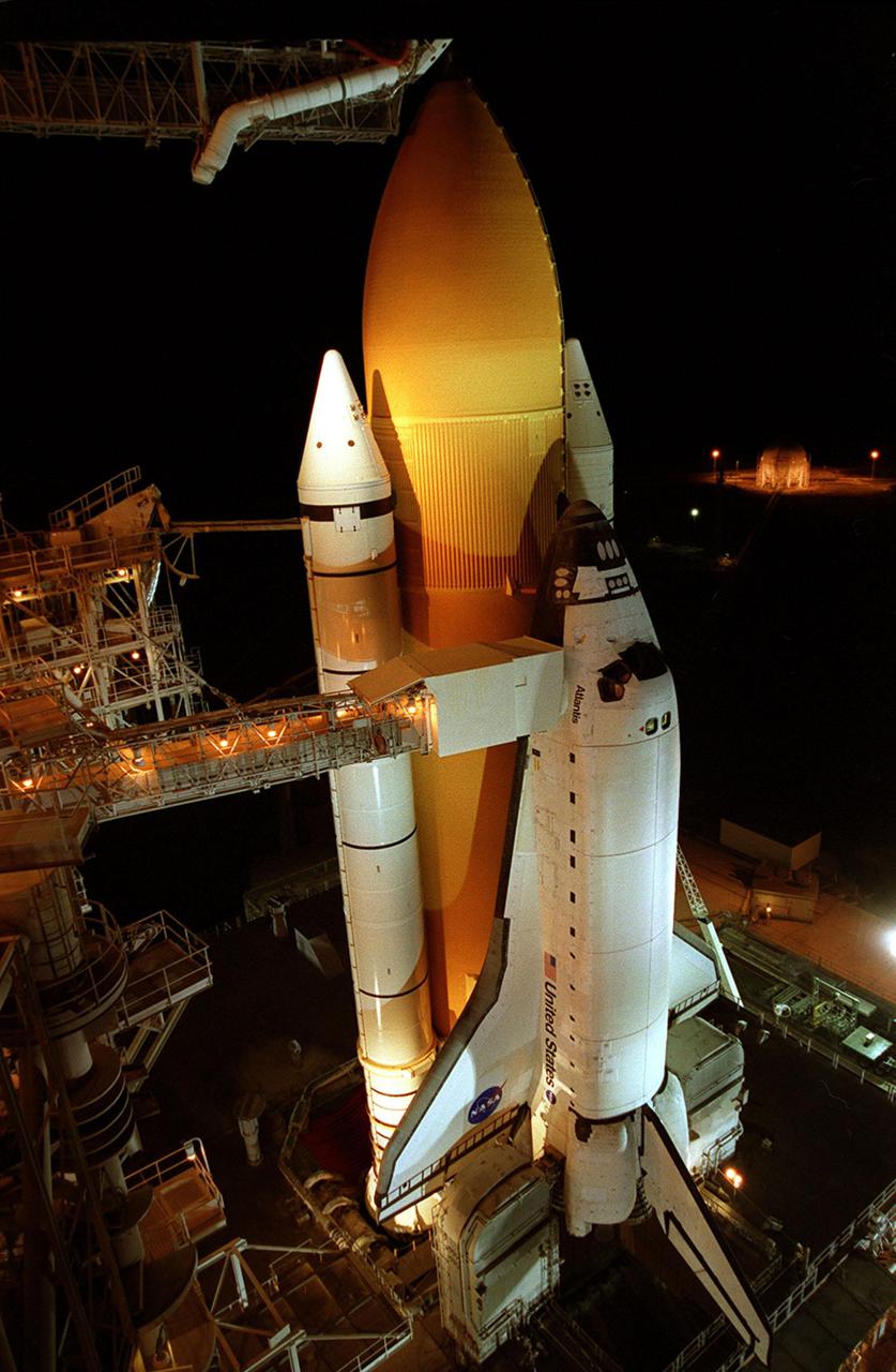This closeup reveals Space Shuttle Atlantis after rollback of the Rotating Service Structure. Extended to the side of Atlantis is the orbiter access arm, with the White Room at its end. The White Room provides entry for the crew into Atlantis’s cockpit. Below Atlantis, on either side of the tail, are the tail service masts. They support the fluid, gas and electrical requirements of the orbiter’s liquid oxygen and liquid hydrogen aft T-0 umbilicals. Atlantis is carrying the U.S. Laboratory Destiny, a key module in the growth of the International Space Station. Destiny will be attached to the Unity node on the Space Station using the Shuttle’s robotic arm. Three spacewalks are required to complete the planned construction work during the 11-day mission. Launch is targeted for 6:11 p.m. EST and the planned landing at KSC Feb. 18 about 1:39 p.m. This mission marks the seventh Shuttle flight to the Space Station, the 23rd flight of Atlantis and the 102nd flight overall in NASA’s Space Shuttle program