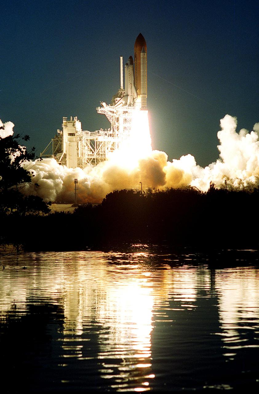 KENNEDY SPACE CENTER, FLA. -- Rising from clouds of smoke and steam, Space Shuttle Atlantis rushes into the night sky as it lifts off from Launch Pad 39A. The glare of the flames and clouds is captured in the water near the pad. Liftoff occurred at 6:13:02 p.m. EST. Along with a crew of five, Atlantis is carrying the U.S. Laboratory Destiny, a key module in the growth of the Space Station. Destiny will be attached to the Unity node on the Space Station using the Shuttle’s robotic arm. Three spacewalks are required to complete the planned construction work during the 11-day mission. This mission marks the seventh Shuttle flight to the Space Station, the 23rd flight of Atlantis and the 102nd flight overall in NASA’s Space Shuttle program. The planned landing is at KSC Feb. 18 about 1:00 p.m. EST