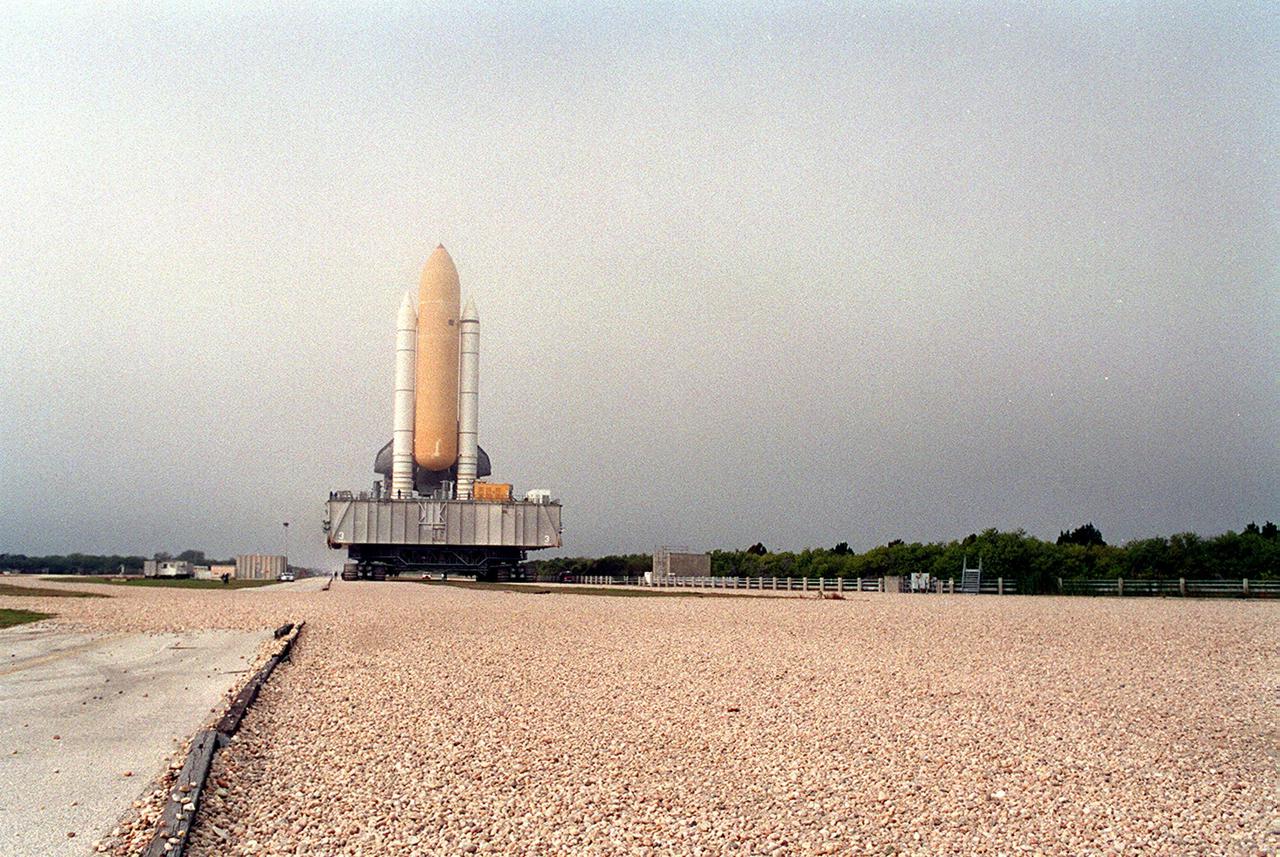 KENNEDY SPACE CENTER, Fla. -- Traveling about 1 mph, Space Shuttle Discovery makes its way along the crawlerway to Launch Pad 39B. The crawlerway is 130 feet wide, consisting of two 40-foot-wide lanes and a 50-foot-wide median. The trip from the Vehicle Assembly Building usually takes about 5 hours. Discovery will be flying on mission STS-102 to the International Space Station. Its payload is the Multi-Purpose Logistics Module Leonardo, a “moving van,” to carry laboratory racks filled with equipment, experiments and supplies to and from the Space Station aboard the Space Shuttle. The flight will also carry the Expedition Two crew up to the Space Station, replacing Expedition One, who will return to Earth on Discovery. Launch is scheduled for March 8 at 6:45 a.m. EST