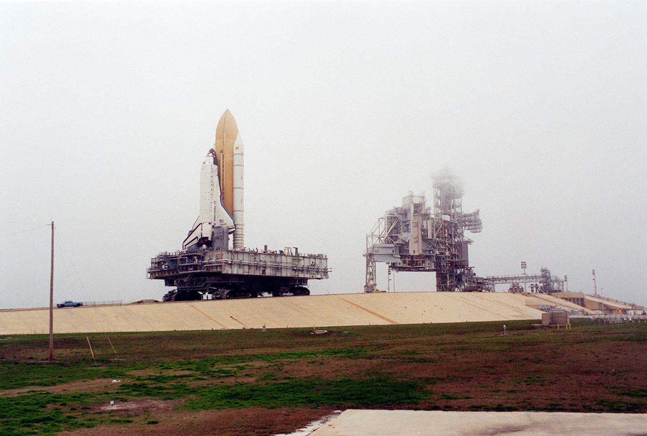 KENNEDY SPACE CENTER, Fla. -- Space Shuttle Discovery, on its Mobile Launcher Platform, approaches the top of Launch Pad 39B. Fog is rolling in above the Fixed Service Structure, where the Shuttle will stand for launch. Discovery will be flying on mission STS-102 to the International Space Station. Its payload is the Multi-Purpose Logistics Module Leonardo, a “moving van,” to carry laboratory racks filled with equipment, experiments and supplies to and from the Space Station aboard the Space Shuttle. The flight will also carry the Expedition Two crew up to the Space Station, replacing Expedition One, who will return to Earth on Discovery. Launch is scheduled for March 8 at 6:45 a.m. EST