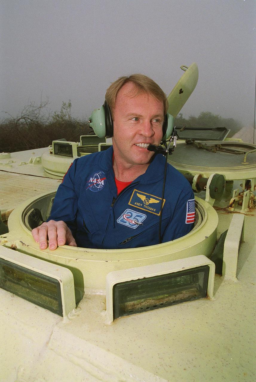STS-102 Mission Specialist Andrew Thomas climbs into the driver’s seat of the M-113 armored carrier he will practice driving. In the event of an emergency at the pad prior to launch, the carrier could be used to transport the crew to a nearby bunker or farther. The STS-102 crew is at KSC to take part in Terminal Countdown Demonstration Test activities, which also include a simulated launch countdown. STS-102 is the eighth construction flight to the International Space Station, carrying as payload the Multi-Purpose Logistics Module Leonardo. Launch on mission STS-102 is scheduled for March 8