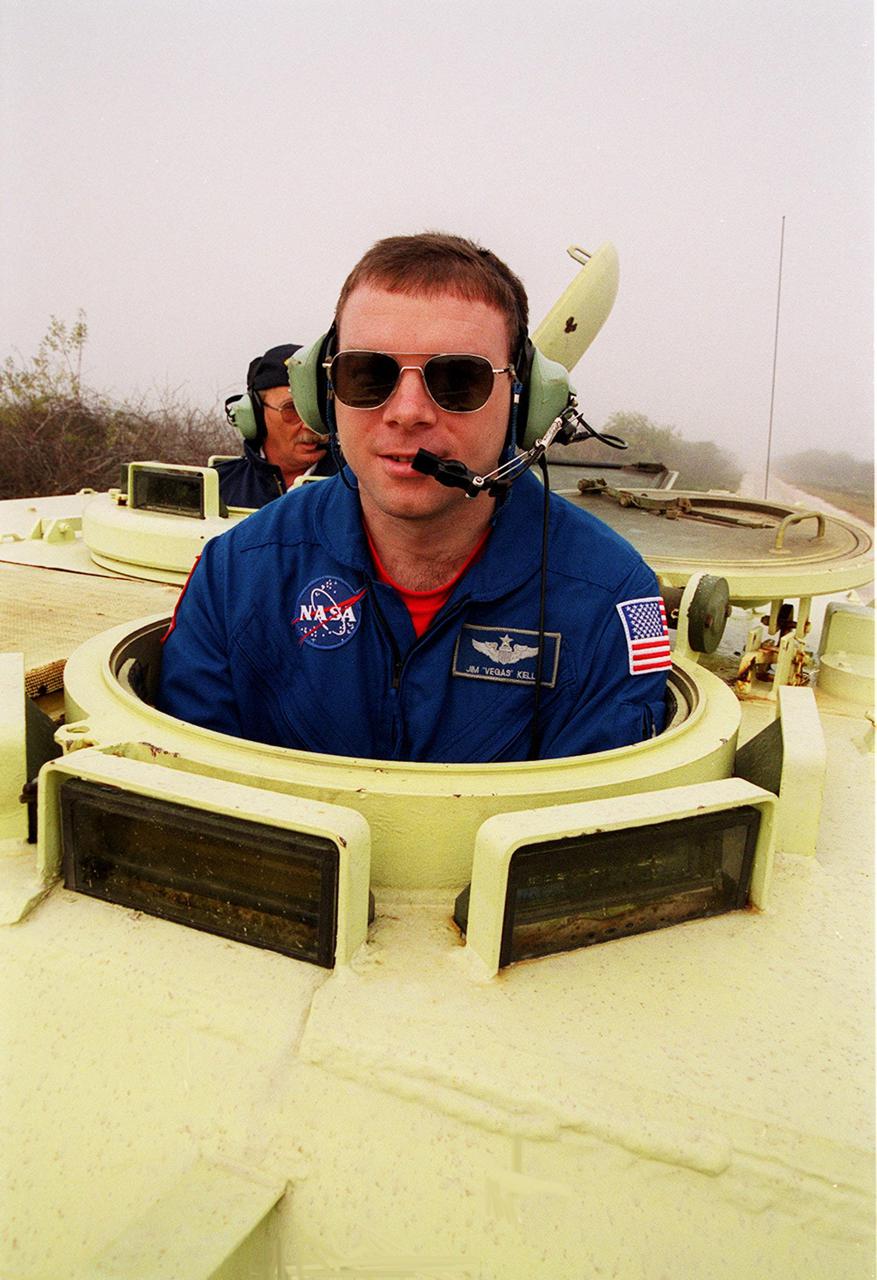 STS-102 Pilot James Kelly gets into the driver’s seat of an M-113 armored carrier near Launch Pad 39B he will practice driving. In the background is Capt. George Hoggard, a training officer with SGS Fire Services. In the event of an emergency at the pad prior to launch, the carrier could be used to transport the crew to a nearby bunker or farther. The STS-102 crew is at KSC to take part in Terminal Countdown Demonstration Test activities, which also include a simulated launch countdown. STS-102 is the eighth construction flight to the International Space Station, carrying as payload the Multi-Purpose Logistics Module Leonardo. Launch on mission STS-102 is scheduled for March 8