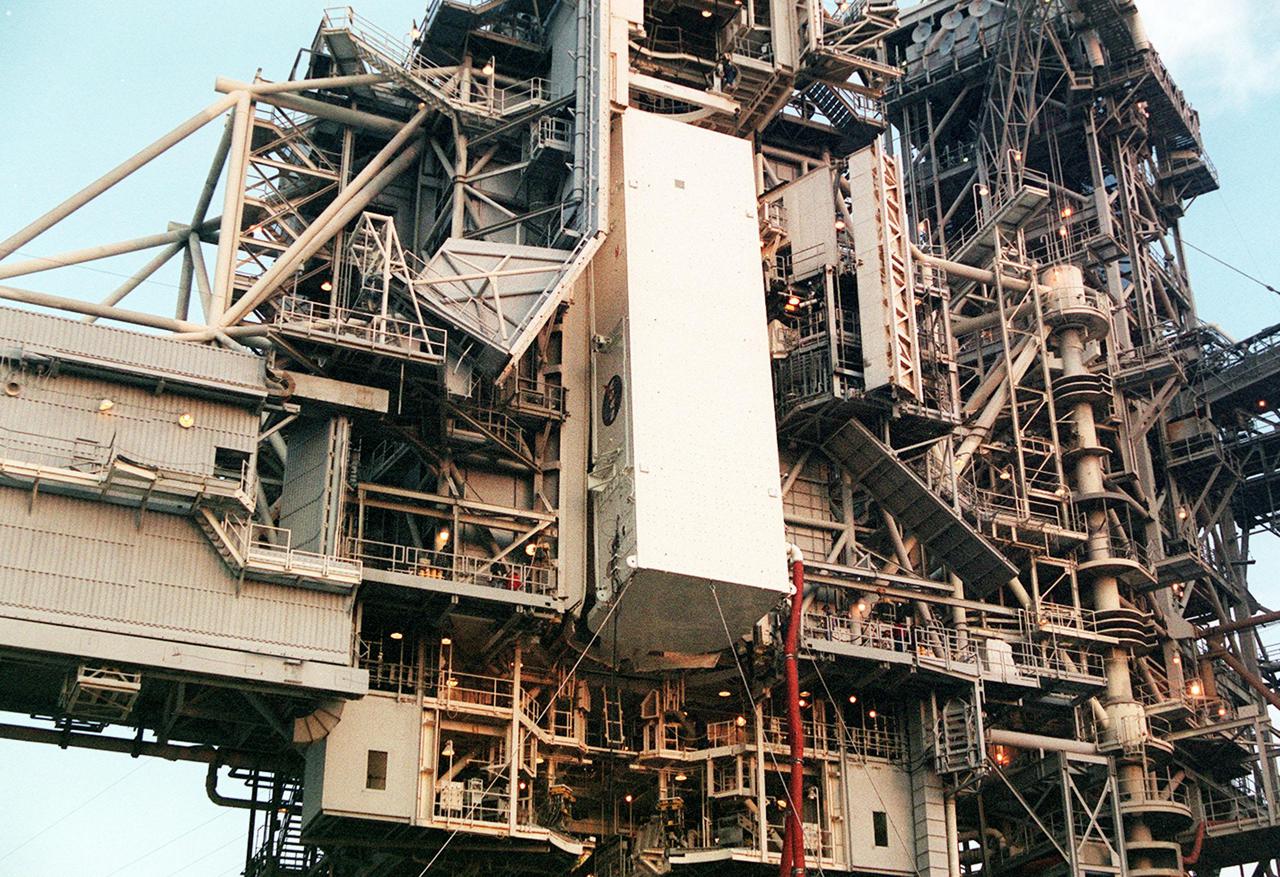 KENNEDY SPACE CENTER, FLA. --  At Launch Pad 39B the payload canister, with the Multi-Purpose Logistics Module Leonardo inside, nears the payload changeout room on the Rotating Service Structure. Umbilical hoses, maintaining a controlled environment for the cargo, are still attached to the lower end of the canister. At the PCR, the payload ground-handling mechanism (PGHM) will be used to transfer Leonardo out of the canister and then into Space Shuttle Discovery’s payload bay. One of Italy’s major contributions to the International Space Station program, Leonardo is a reusable logistics carrier. It is the primary delivery system used to resupply and return Station cargo requiring a pressurized environment. Leonardo is the primary payload on mission STS-102 and will deliver up to 10 tons of laboratory racks filled with equipment, experiments and supplies for outfitting the newly installed U.S. Laboratory Destiny. STS-102 is scheduled to launch March 8 at 6:45 a.m. EST