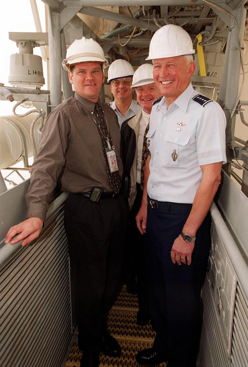 After the rollout of Space Shuttle Discovery, Brig. Gen. Donald Pettit (2nd from left), Center Director Roy Bridges, and Gen. Ralph Everhart take a look at the Fixed Service Structure on Launch Pad 39B. At far left is Dave Rainer. Gen. Everhart is Commander of the Space Command and Gen. Pettit is Commander of the 45th Space Wing, Cape Canaveral