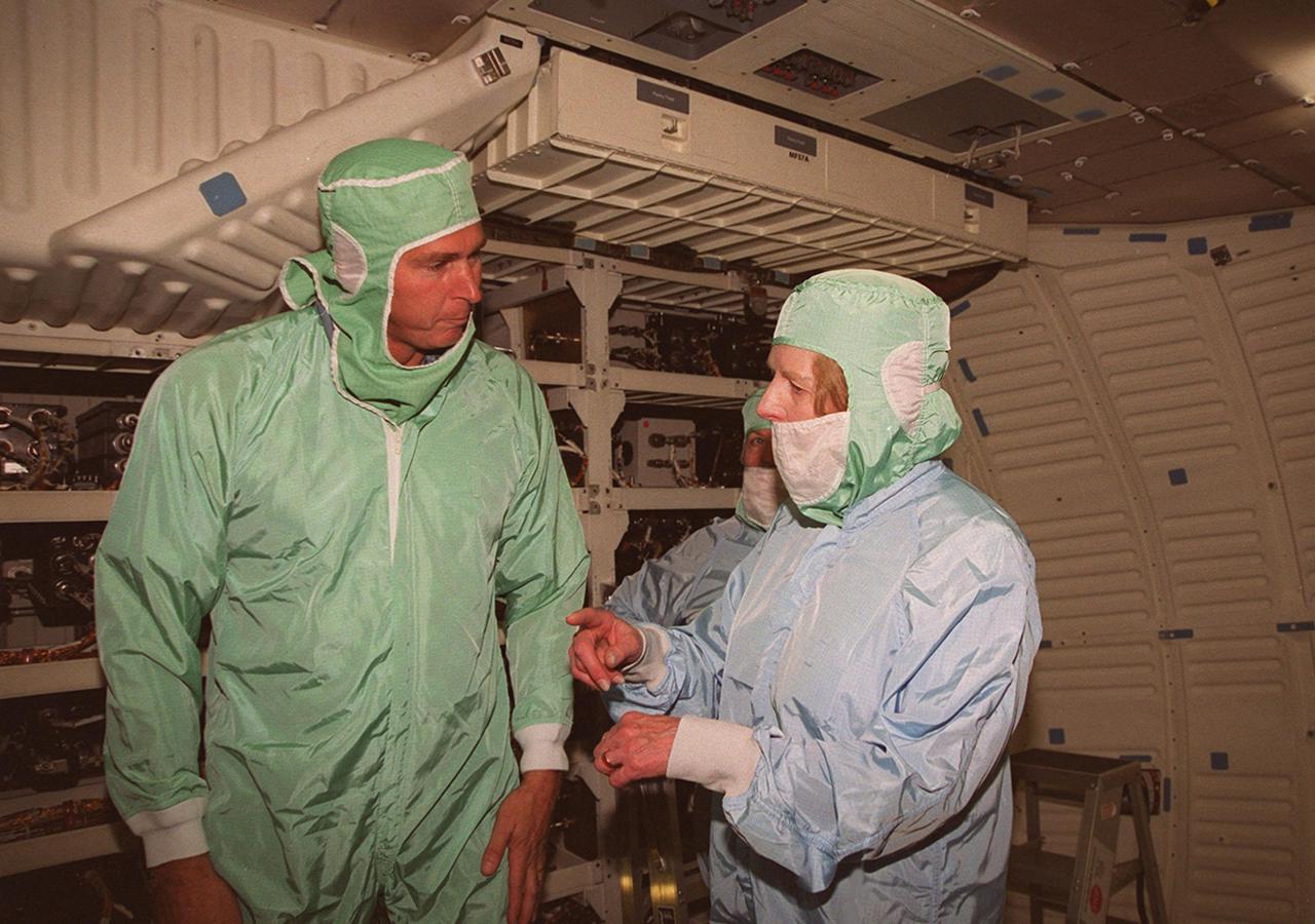 During a tour of KSC, Lady Margaret Thatcher (right), former Prime Minister of Britain, gets an inside look at the orbiter Endeavour. Here she talks with United Space Alliance technician, Mike Parrish (left). The orbiter, which is in the Orbiter Processing Facility bay 2, is flying on mission STS-100, the ninth construction flight to the International Space Station.