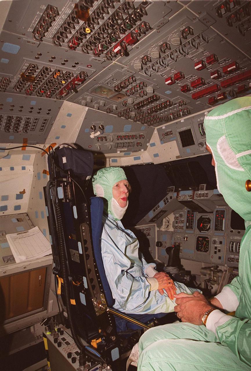 During a tour of KSC, Lady Margaret Thatcher (left), former Prime Minister of Britain, talks with United Space Alliance technician Mike Parrish (right) while sitting in the cockpit of the orbiter Endeavour. The orbiter, which is in the Orbiter Processing Facility bay 2, is flying on mission STS-100, the ninth construction flight to the International Space Station