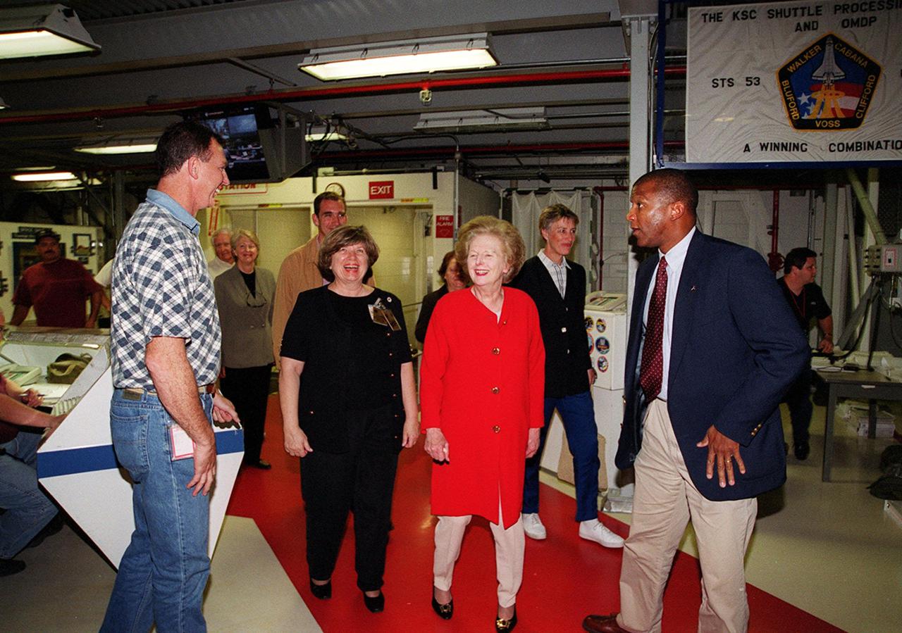 Walking into the Orbiter Processing Facility bay 2 while on a tour of KSC is Lady Margaret Thatcher (second from right), former Prime Minister of Britain.  At far right is NASA Test Director Kelvin Manning.  At left is United Space Alliance technician Mike Parrish, who will be Thatcher’s guide inside the orbiter Endeavour; second from left is JoAnn H. Morgan, director, External Relations and Business Development at KSC.  Endeavour is next flying on mission STS-100, the ninth construction flight to the International Space Station