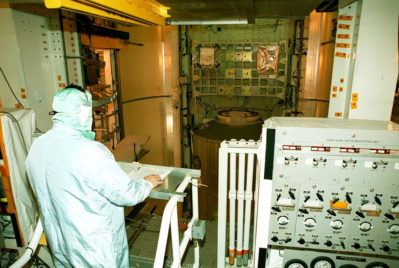 KENNEDY SPACE CENTER, FLA. -- From inside the Payload Changeout Room, Launch Pad 39B, a technician monitors the closing of the payload bay doors in Space Shuttle Discovery. Visible is the Integrated Cargo Carrier at top and the Multi-Purpose Logistics Module Leonardo below. Discovery is scheduled to launch March 8 at 6:42 a.m. EST on STS-102, the eighth construction flight to the International Space Station. The primary delivery system used to resupply and return Station cargo requiring a pressurized environment, Leonardo will deliver up to 10 tons of laboratory racks filled with equipment, experiments and supplies for outfitting the newly installed U.S. Laboratory Destiny