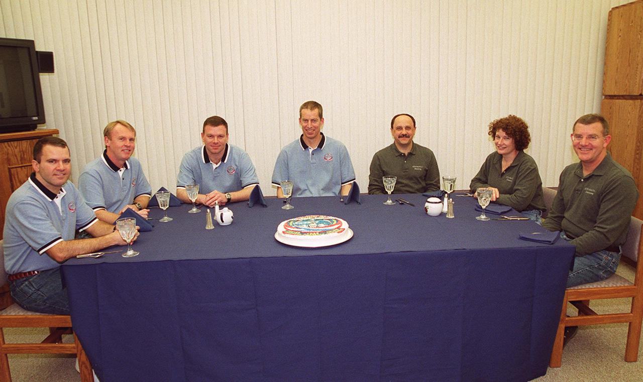 KENNEDY SPACE CENTER, FLA. -- The STS-102 crew enjoys a snack before beginning suitup procedures for launch of Space Shuttle Discovery on the eighth construction flight to the International Space Station. From left, seated are Mission Specialists Paul Richards and Andrew Thomas, Pilot James Kelly and Commander James Wetherbee; Mission Specialists Yury Usachev, representing the Russian Aviation and Space Agency, Susan Helms and James Voss. Usachev, Helms and Voss are wearing different shirts because they also are the Expedition Two crew who will be replacing Expedition One on the International Space Station. Discovery is scheduled to launch March 8 at 6:42 a.m. EST, carrying the Multi-Purpose Logistics Module Leonardo. The primary delivery system used to resupply and return Station cargo requiring a pressurized environment, Leonardo will deliver up to 10 tons of laboratory racks filled with equipment, experiments and supplies for outfitting the newly installed U.S. Laboratory Destiny.