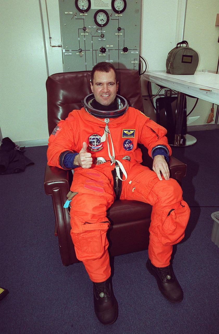 STS-102 Mission Specialist Paul Richards signals thumbs up for launch as he suits up in the Operations and Checkout Building. This will be Richards’ first Shuttle launch. . STS-102 is the eighth construction flight to the International Space Station, carrying the Multi-Purpose Logistics Module Leonardo. The primary delivery system used to resupply and return Station cargo requiring a pressurized environment, Leonardo will deliver up to 10 tons of laboratory racks filled with equipment, experiments and supplies for outfitting the newly installed U.S. Laboratory Destiny. In addition, three of the crew members Mission Specialists James Voss, Susan Helms and Yury Usachev, known as Expedition Two are flying to the Station to replace Expedition One, who will return to Earth on Discovery. Discovery is set to launch March 8 at 6:42 a.m. EST. The 12-day mission is expected to end with a landing at KSC on March 20
