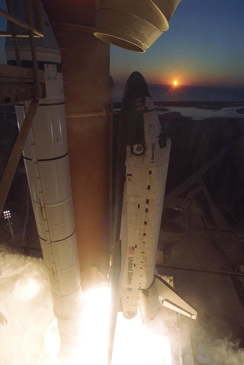 KENNEDY SPACE CENTER, Fla. -- As Space Shuttle Discovery clears Launch Pad 39B, the sun peers over the horizon of the Atlantic Ocean.Liftoff of Discovery on mission STS-102 occurred at 6:42:09 EST for the eighth flight to the International Space Station