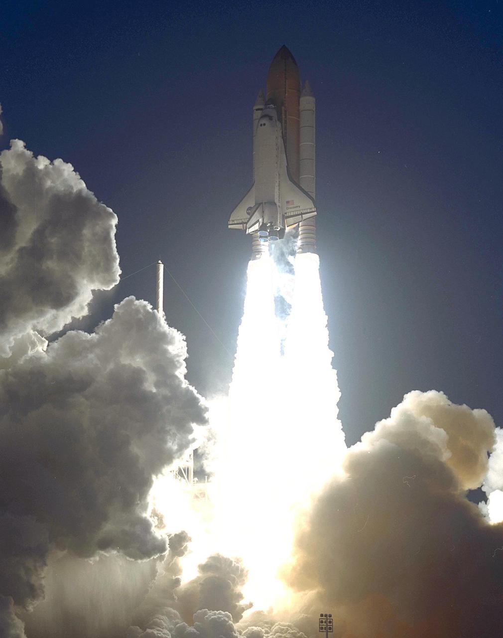 KENNEDY SPACE CENTER, Fla. -- Clouds of smoke and steam seem to break away as Space Shuttle Discovery blasts off from Launch Pad 39B on mission STS-102. Liftoff occurred at 6:42:09 EST for this eighth flight to the International Space Station