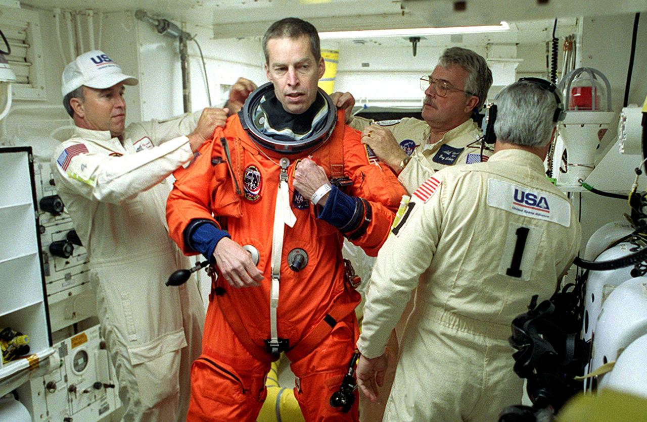 In the White Room, Launch Pad 39B, STS-102 Commander James Wetherbee gets help with final suit preparations before entering Space Shuttle Discovery. STS-102 is Wetherbee’s fifth Shuttle flight. Discovery is carrying the Multi-Purpose Logistics Module Leonardo on the eighth construction flight to the International Space Station. The primary delivery system used to resupply and return Station cargo requiring a pressurized environment, Leonardo will deliver up to 10 tons of laboratory racks filled with equipment, experiments and supplies for outfitting the newly installed U.S. Laboratory Destiny. In addition, Discovery is transporting Expedition Two, three crew members who are replacing Expedition One on the Station. Discovery is set to launch March 8 at 6:42 a.m. EST. The 12-day mission is expected to end with a landing at KSC on March 20