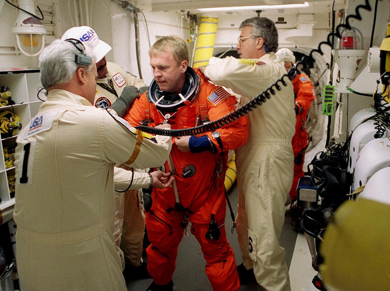 Before entering Space Shuttle Discovery, STS-102 Mission Specialist Andrew Thomas is helped with his launch and entry suit by technicians in the White Room. The mission is Thomas’s third Shuttle flight. Discovery is carrying the Multi-Purpose Logistics Module Leonardo on the eighth construction flight to the International Space Station. The primary delivery system used to resupply and return Station cargo requiring a pressurized environment, Leonardo will deliver up to 10 tons of laboratory racks filled with equipment, experiments and supplies for outfitting the newly installed U.S. Laboratory Destiny. Discovery is set to launch March 8 at 6:42 a.m. EST. The 12-day mission is expected to end with a landing at KSC on March 20