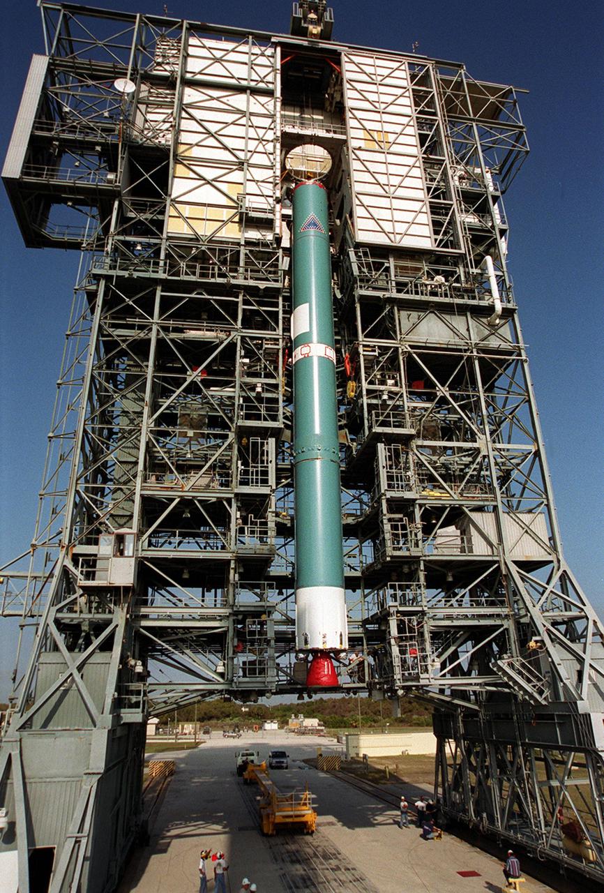 The first stage of a Boeing Delta rocket is lifted vertically up the gantry on Launch Pad 17-A, Cape Canaveral Air Force Station. The rocket will carry the 2001 Mars Odyssey Orbiter, scheduled for launch April 7, 2001. Mars Odyssey contains three science instruments: THEMIS, the Gamma Ray Spectrometer (GRS), and the Mars Radiation Environment Experiment (MARIE). THEMIS will map the mineralogy and morphology of the Martian surface using a high-resolution camera and a thermal infrared imaging spectrometer. The GRS will achieve global mapping of the elemental composition of the surface and determine the abundance of hydrogen in the shallow subsurface. The MARIE will characterize aspects of the near-space radiation environment with regards to the radiation-related risk to human explorers