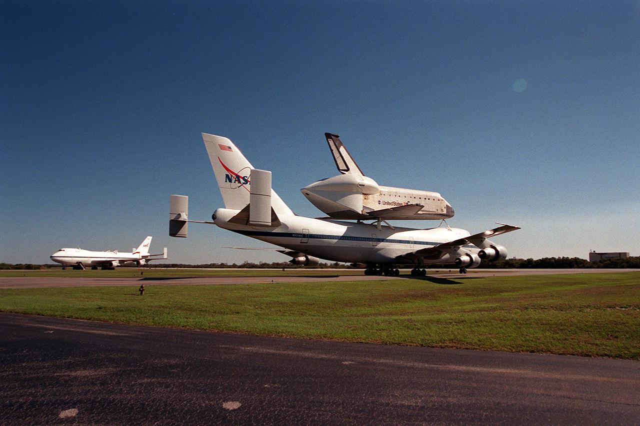 The Shuttle Carrier Aircraft with orbiter Columbia on top taxis at the Cape Canaveral Air Force Station Skid Strip. In the background is another SCA, which brought Atlantis back to KSC from California. The ferry flight began in California March 1. Unfavorable weather conditions kept it on the ground at Dyess AFB, Texas, until it could return to Florida. Columbia is returning from a 17-month-long modification and refurbishment process as part of a routine maintenance plan. The orbiter will next fly on mission STS-107, scheduled Oct. 25