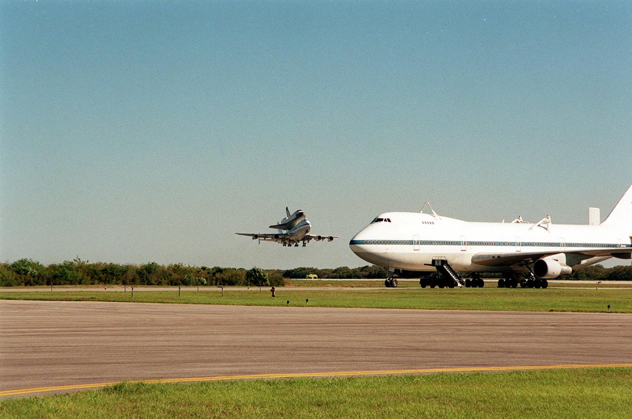 The Shuttle Carrier Aircraft with orbiter Columbia on top takes off from the Cape Canaveral Air Force Station Skid Strip. In the foreground is another SCA, which brought Atlantis back to KSC from California. The ferry flight began in California March 1. Unfavorable weather conditions kept it on the ground at Dyess AFB, Texas, until it could return to Florida. Columbia is returning from a 17-month-long modification and refurbishment process as part of a routine maintenance plan. The orbiter will next fly on mission STS-107, scheduled Oct. 25