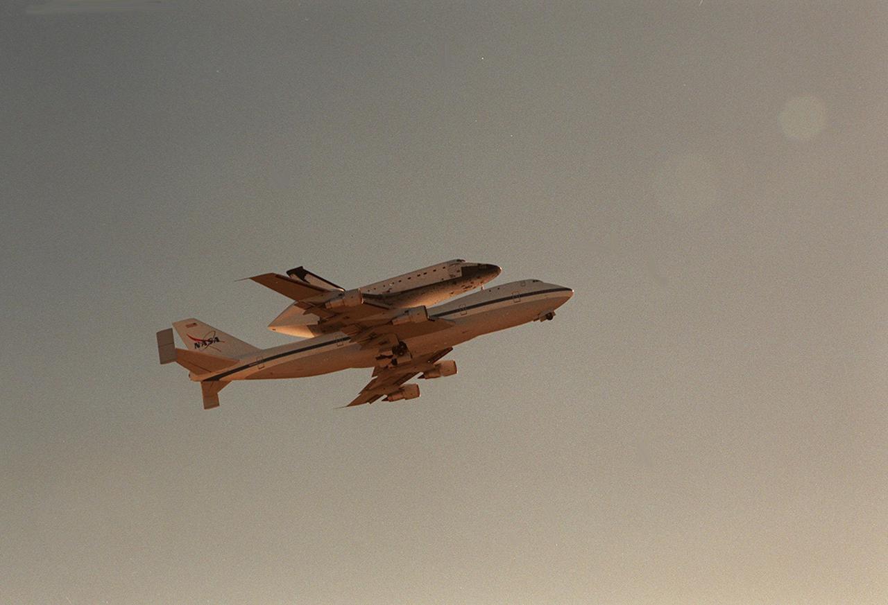 The Shuttle Carrier Aircraft with orbiter Columbia on top soars through the sky over the Space Coast of Florida as it returns to KSC from Cape Canaveral Air Force Station. The ferry flight began in California March 1. Unfavorable weather conditions kept it on the ground at Dyess AFB, Texas, until it could return to Florida. It landed temporarily at the CCAFS Skid Strip until Atlantis, which had alread landed at the SLF, could be transferred Columbia is returning from a 17-month-long modification and refurbishment process as part of a routine maintenance plan. The orbiter will next fly on mission STS-107, scheduled Oct. 25